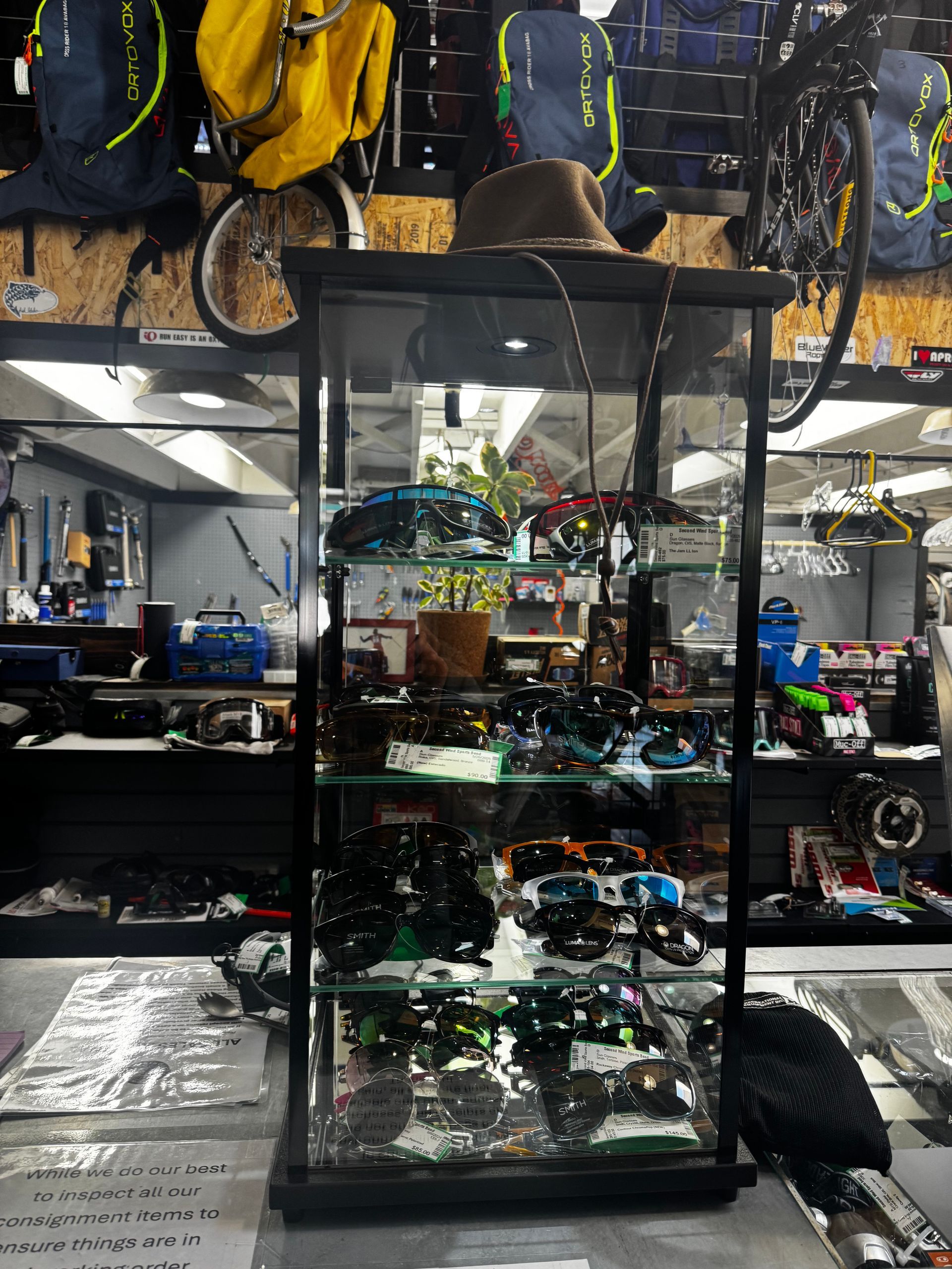 A glass display case with a hat on top of it