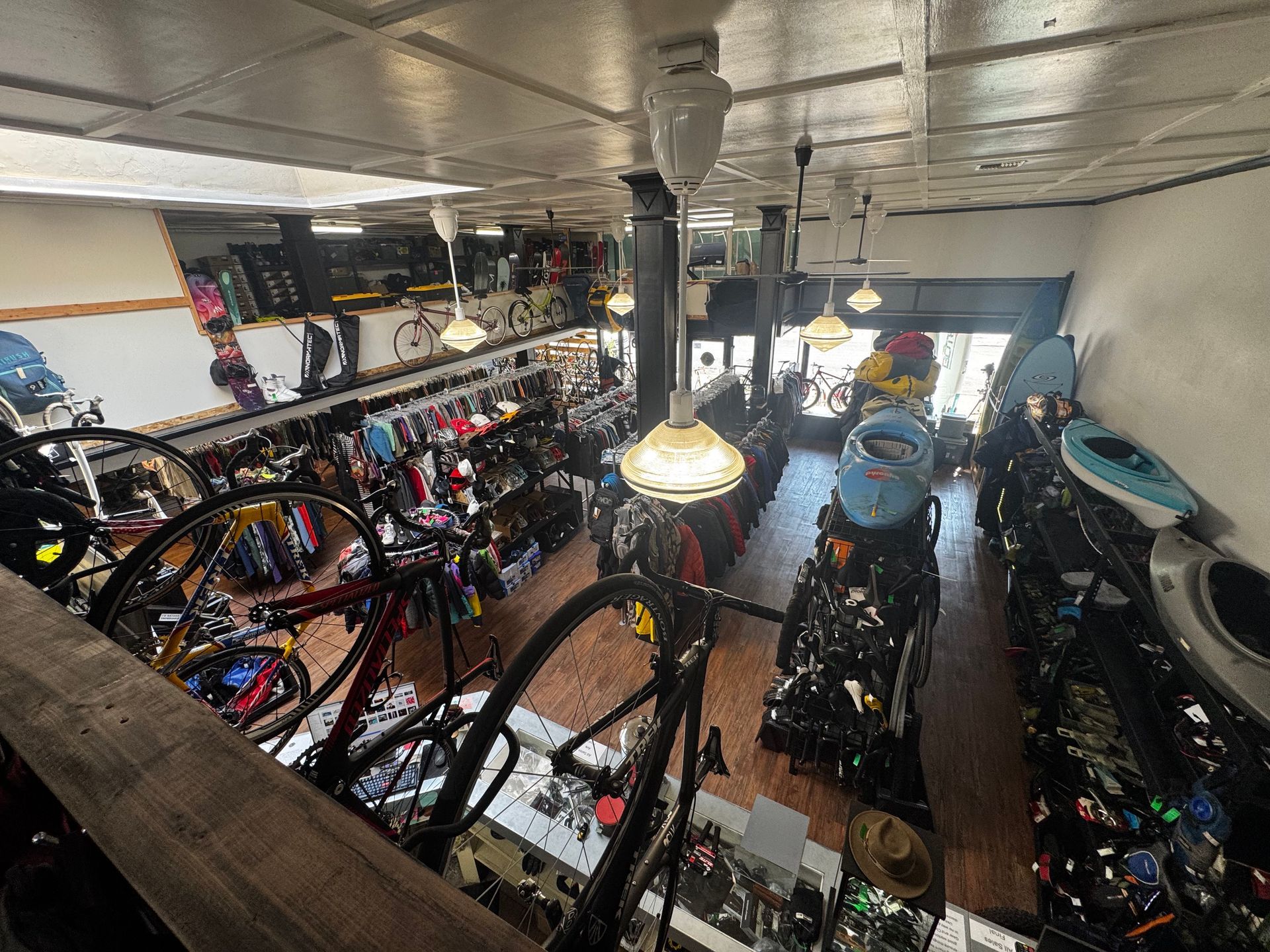An aerial view of a bicycle shop filled with lots of bicycles and kayaks.