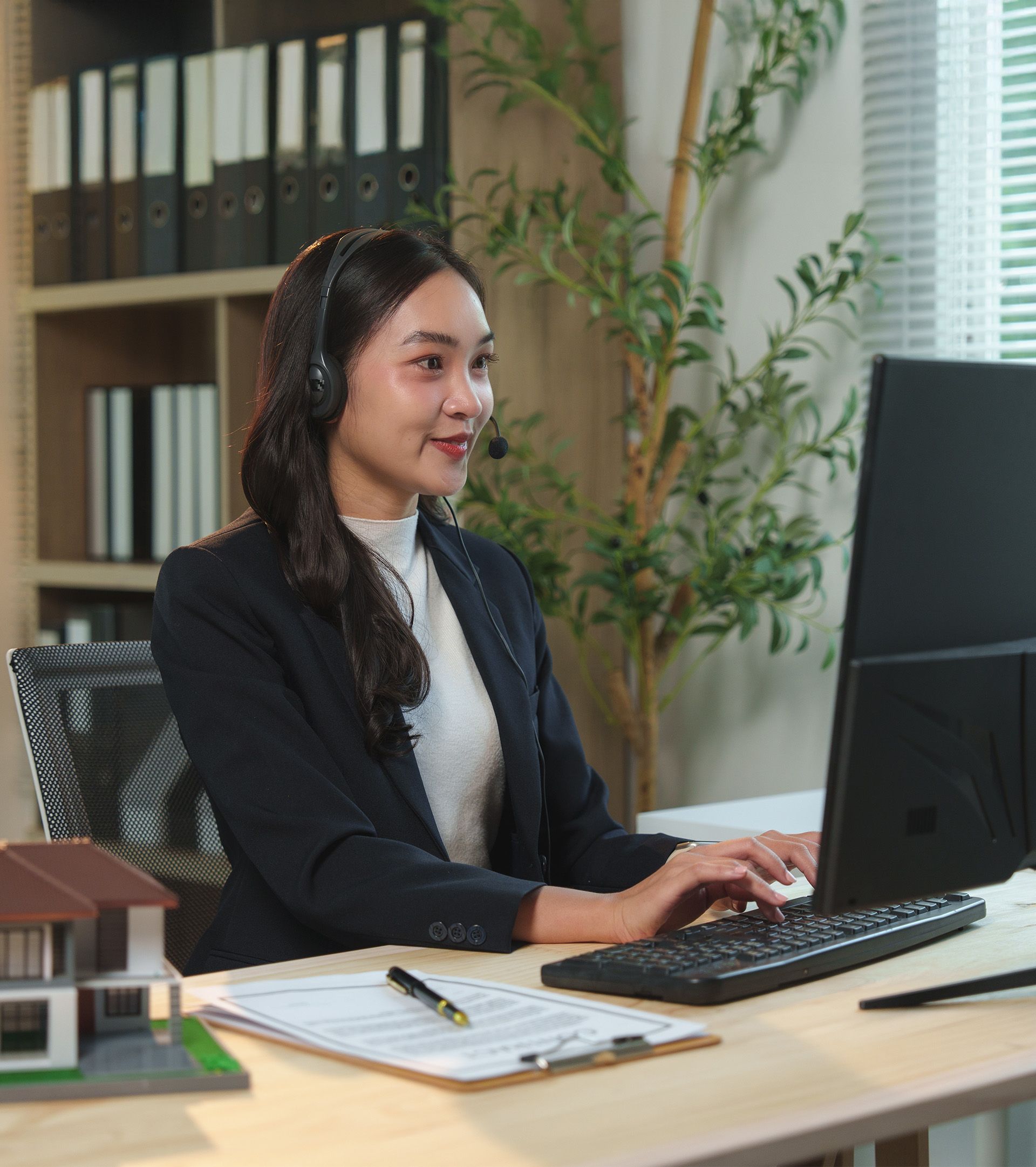 Woman using laptop with a blue screen of death, appearing distressed. Beside her is a white mug on a wooden table.