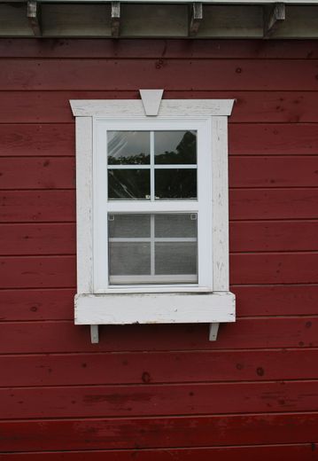 A red building with a white window on it