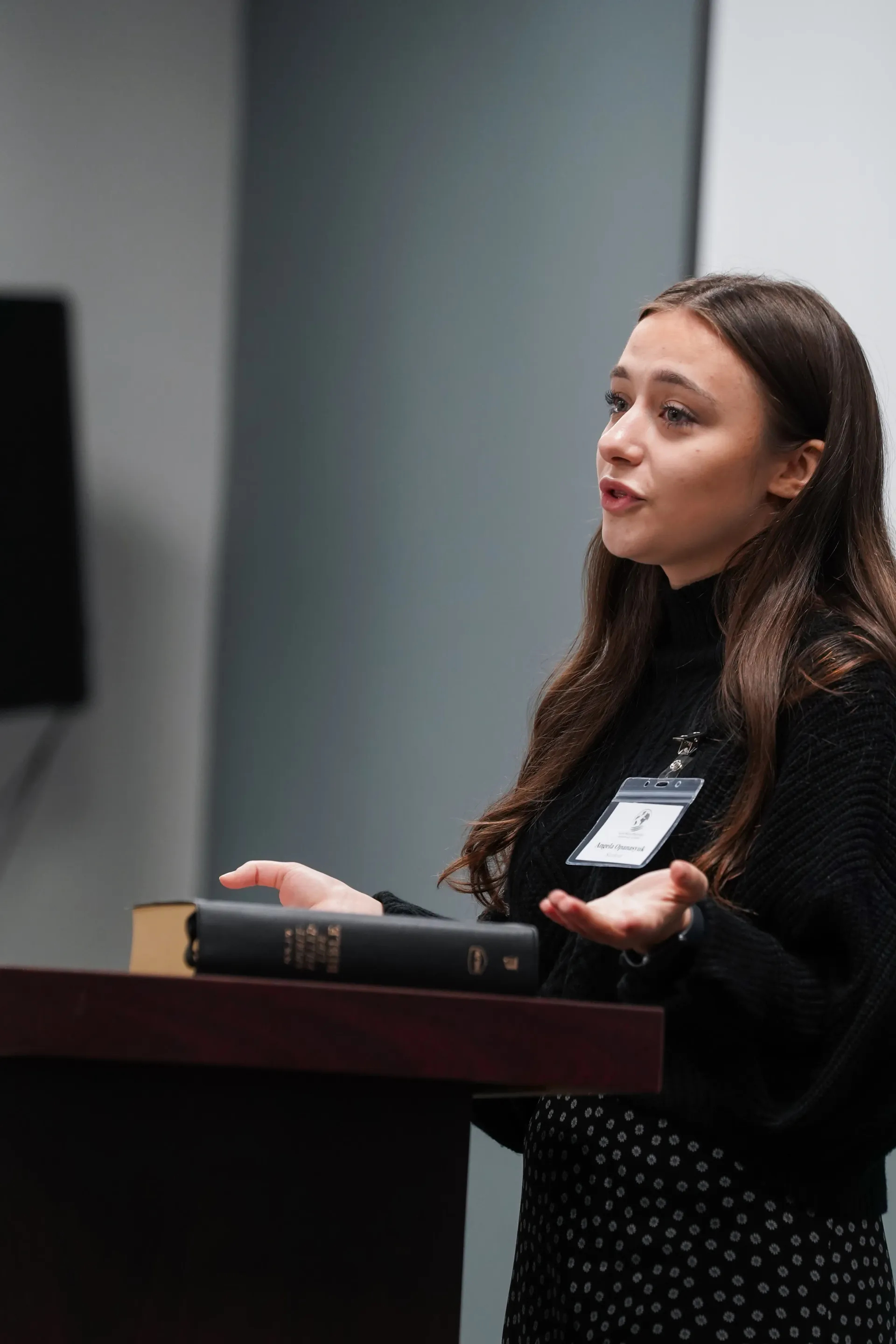 A woman is standing at a podium giving a speech.