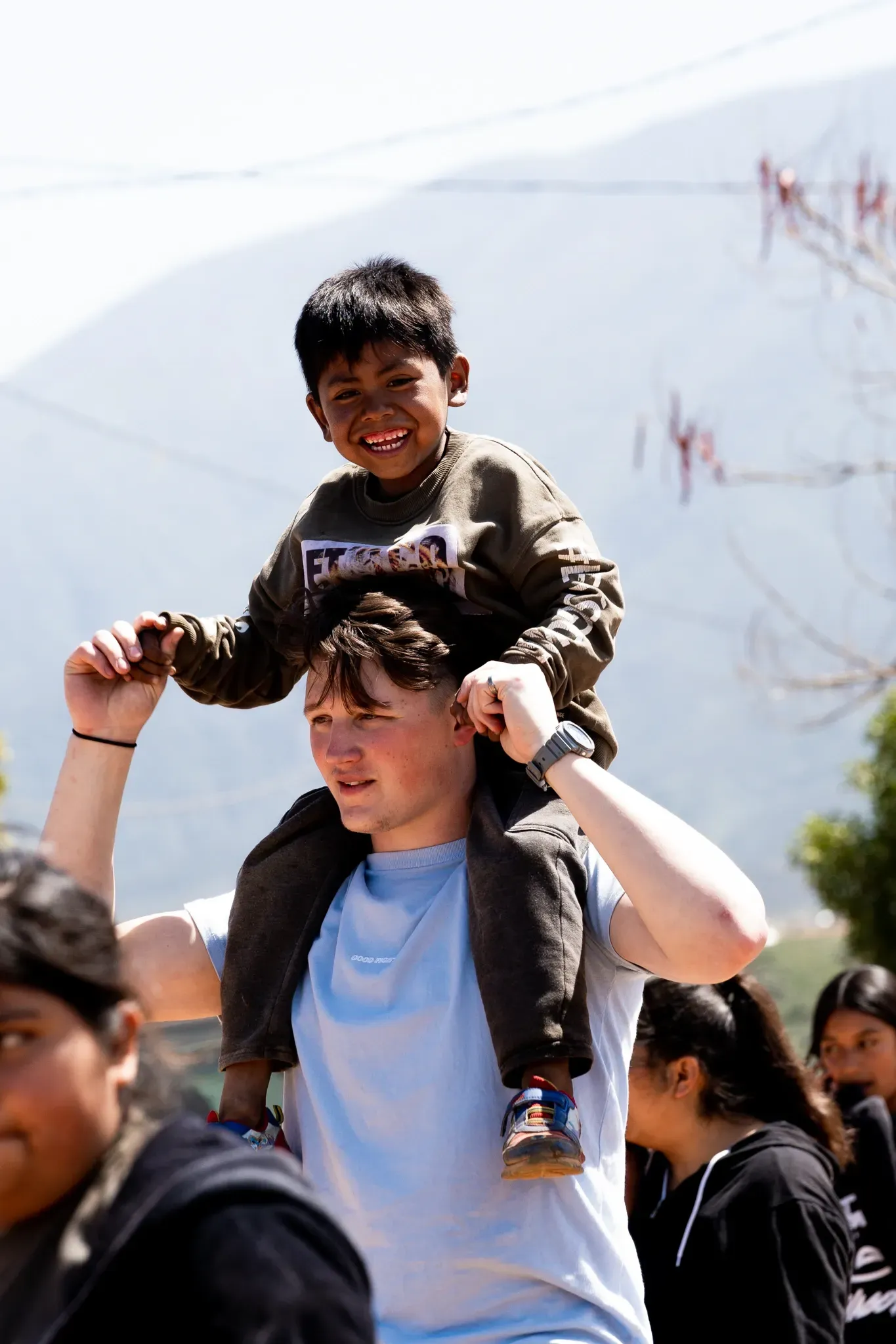 A woman in a red and white striped shirt is clapping her hands.