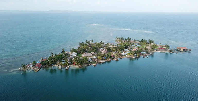 An aerial view of a small island in the middle of the ocean.