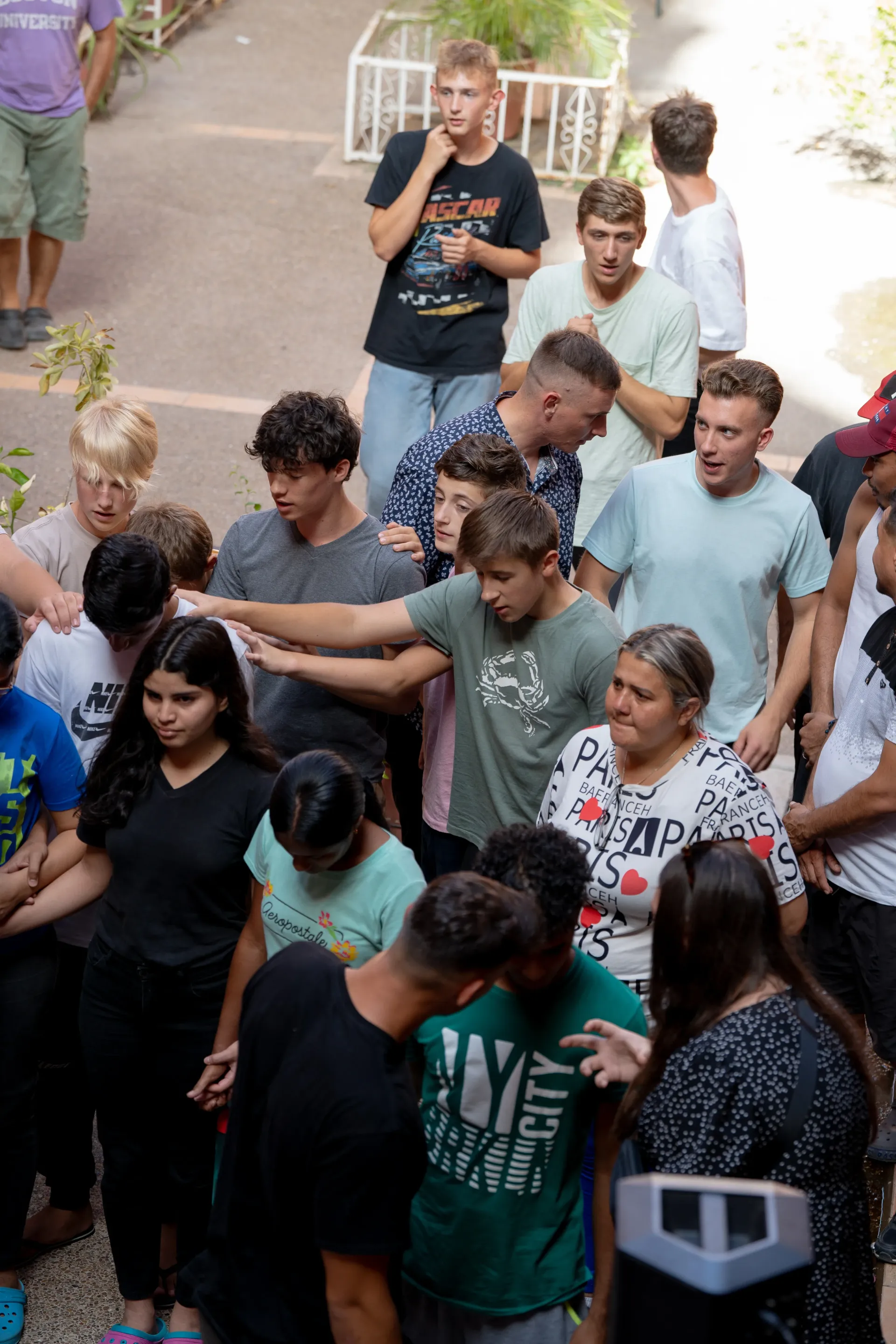 A group of people are standing in a line holding hands.