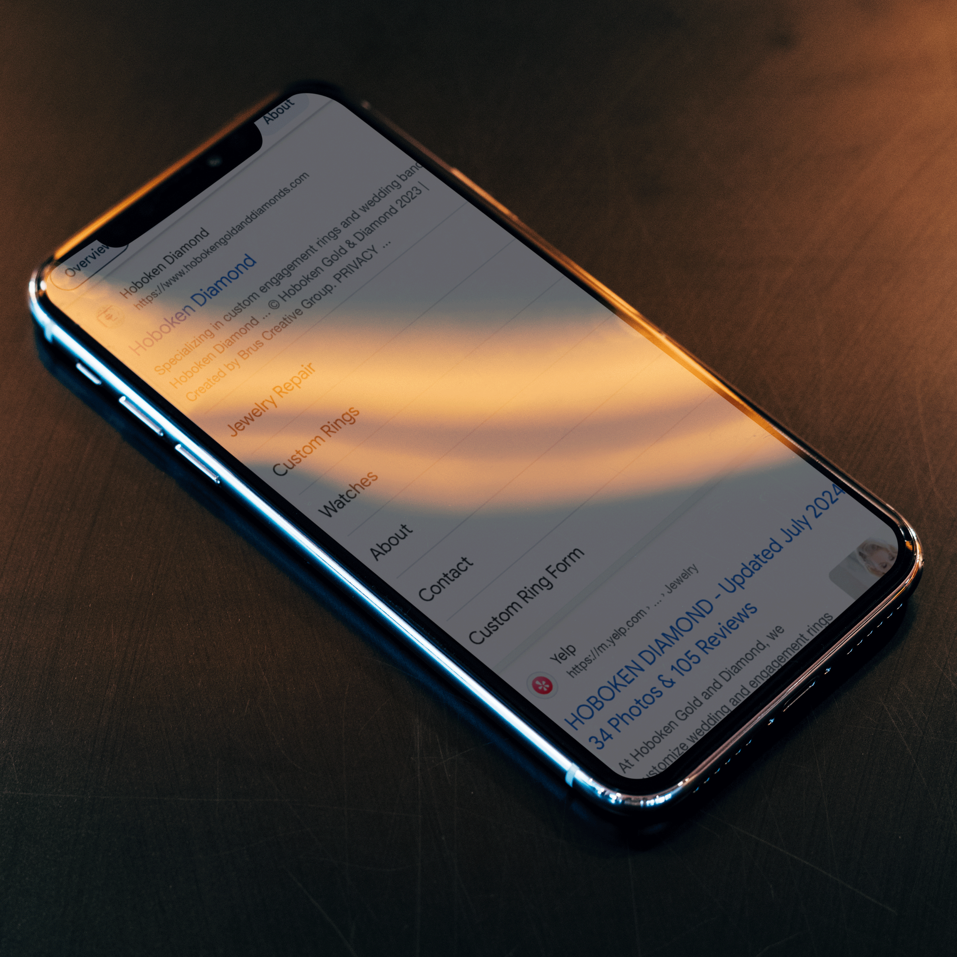 A cell phone with the word contact on the screen.