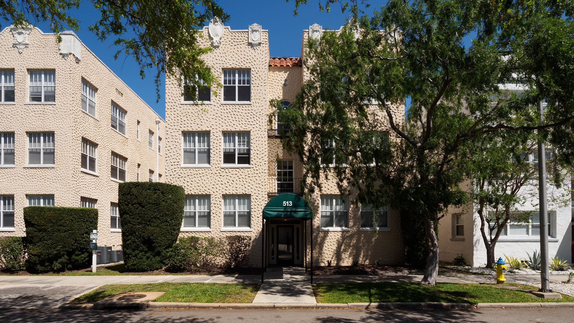 Photo of the entrance to a building, showing the size of it, taken from the street