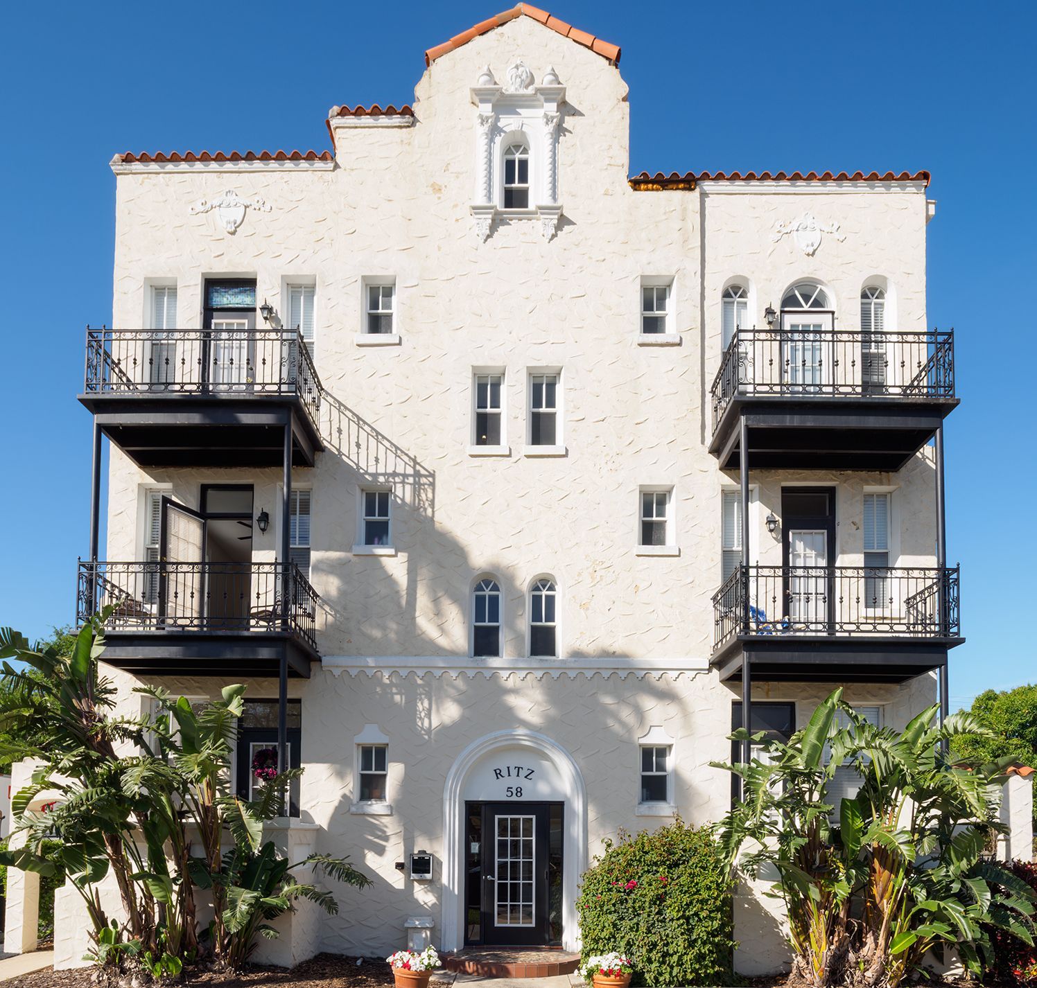 Photo of a three story building, with balconies