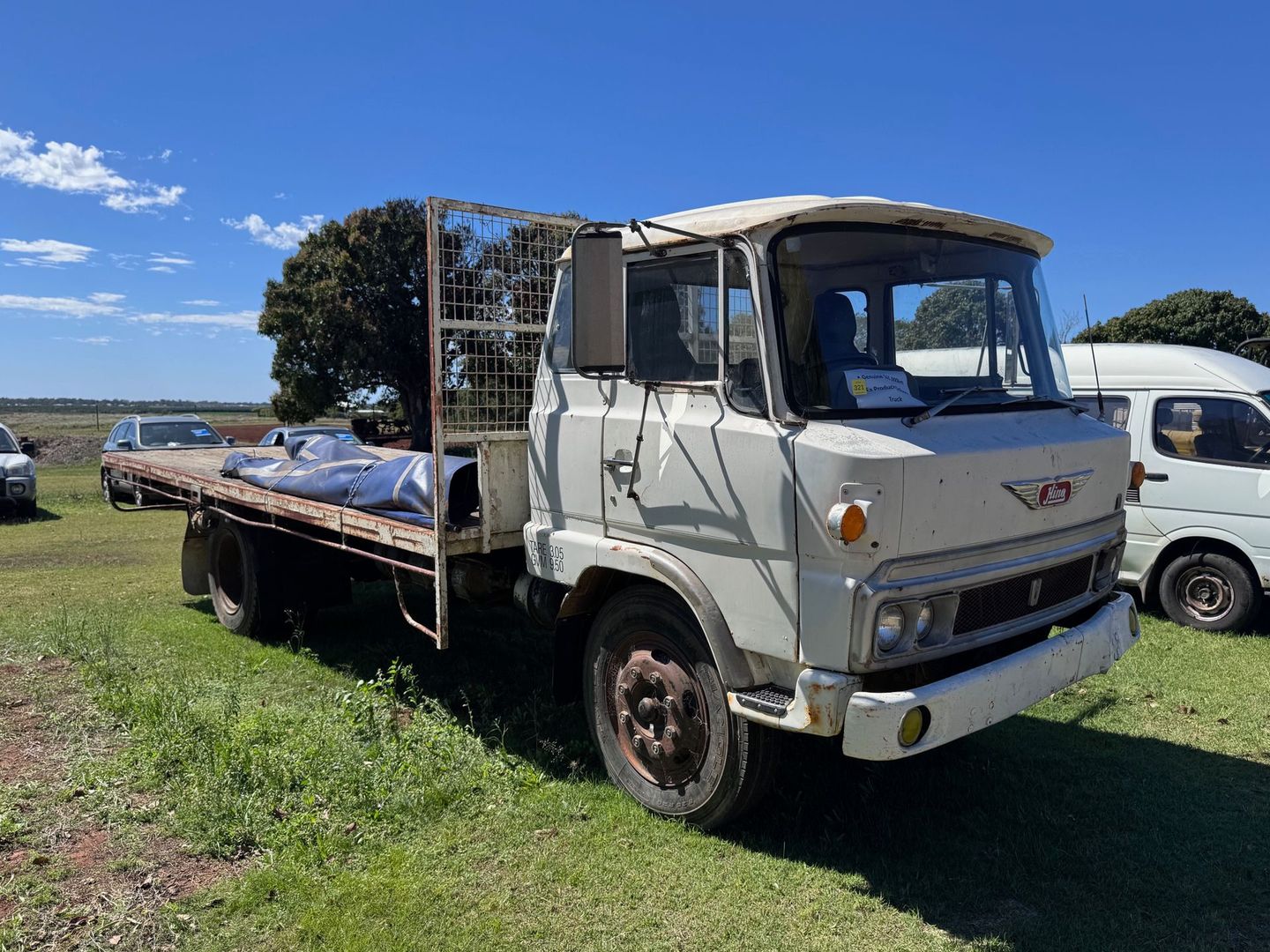 White Vintage Hino Flatbed Truck on Grass — Bundaberg Auction Centre in Gooburrum, QLD