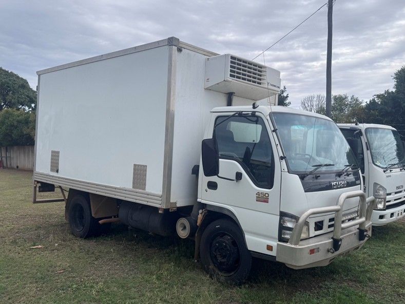 White Refrigerated Isuzu Truck Parked on Grass — Bundaberg Auction Centre in Gooburrum, QLD