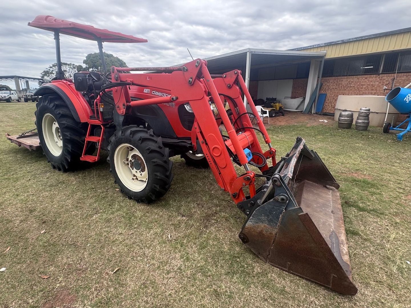 Red Tractor with Front-End Loader — Bundaberg Auction Centre in Gooburrum, QLD