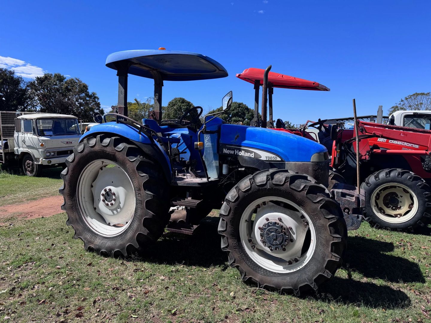 Blue New Holland Tractor on Grass — Bundaberg Auction Centre in Gooburrum, QLD