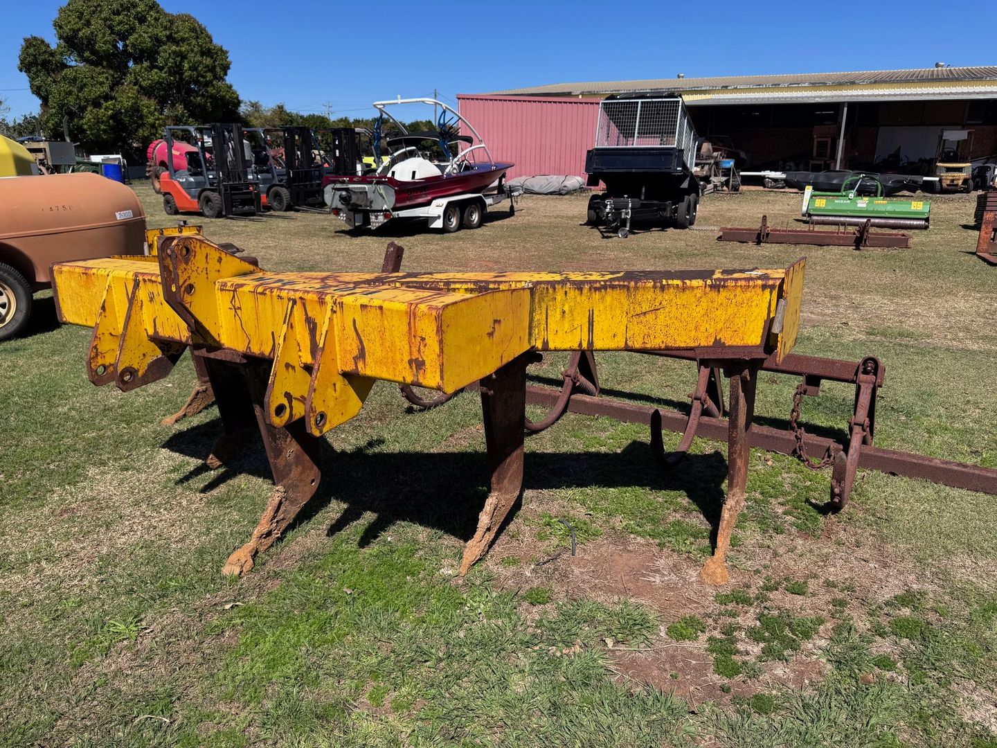 An Old, Green Plow in A Grassy Field — Bundaberg Auction Centre in Gooburrum, QLD