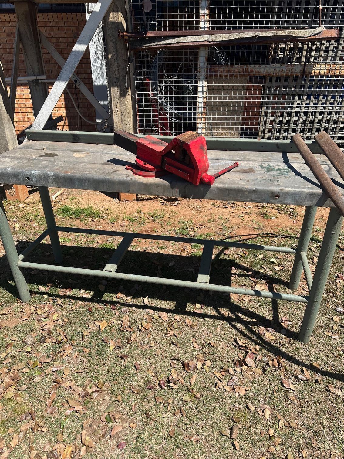 Red Metal Tool on A Grey Metal Workbench Outdoors — Bundaberg Auction Centre in Gooburrum, QLD