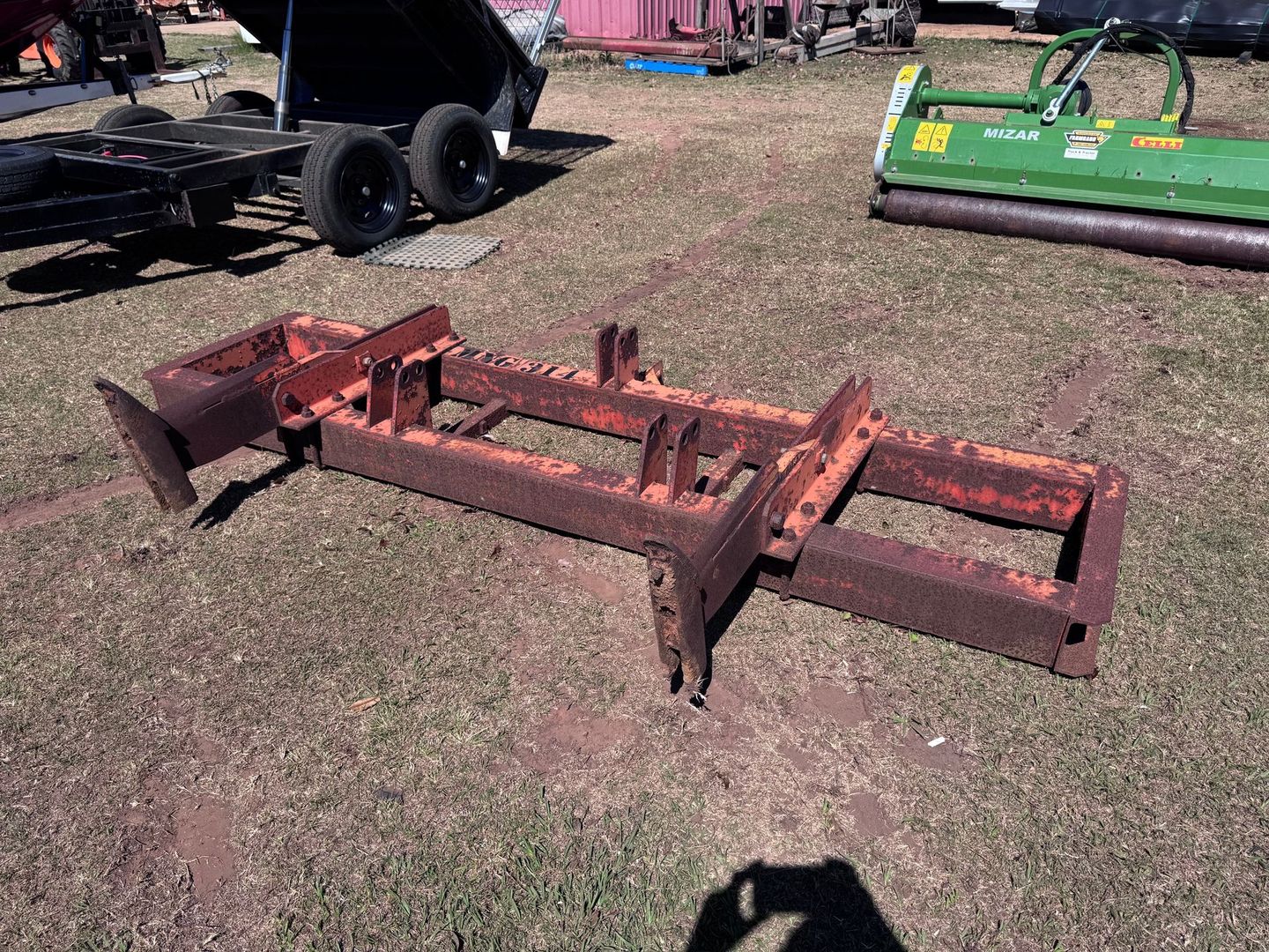 Rusty Orange Metal Agricultural Implement on Grass — Bundaberg Auction Centre in Gooburrum, QLD