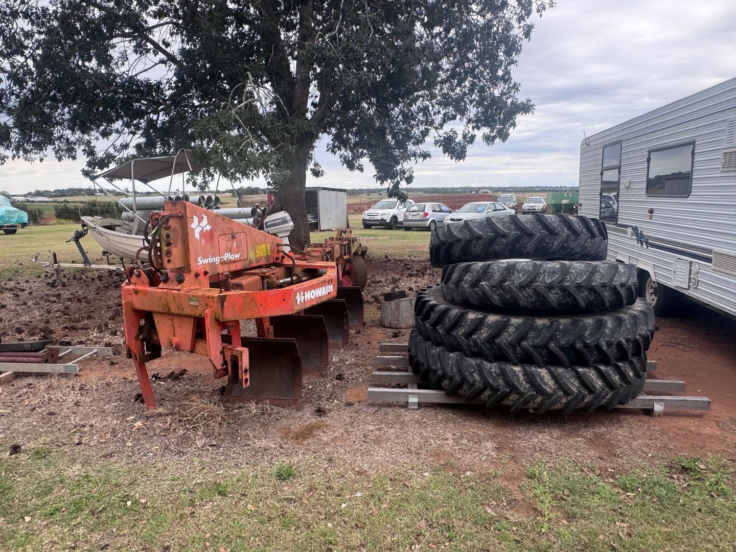 Orange Plow and Tractor Tires Sit Outside — Bundaberg Auction Centre in Gooburrum, QLD