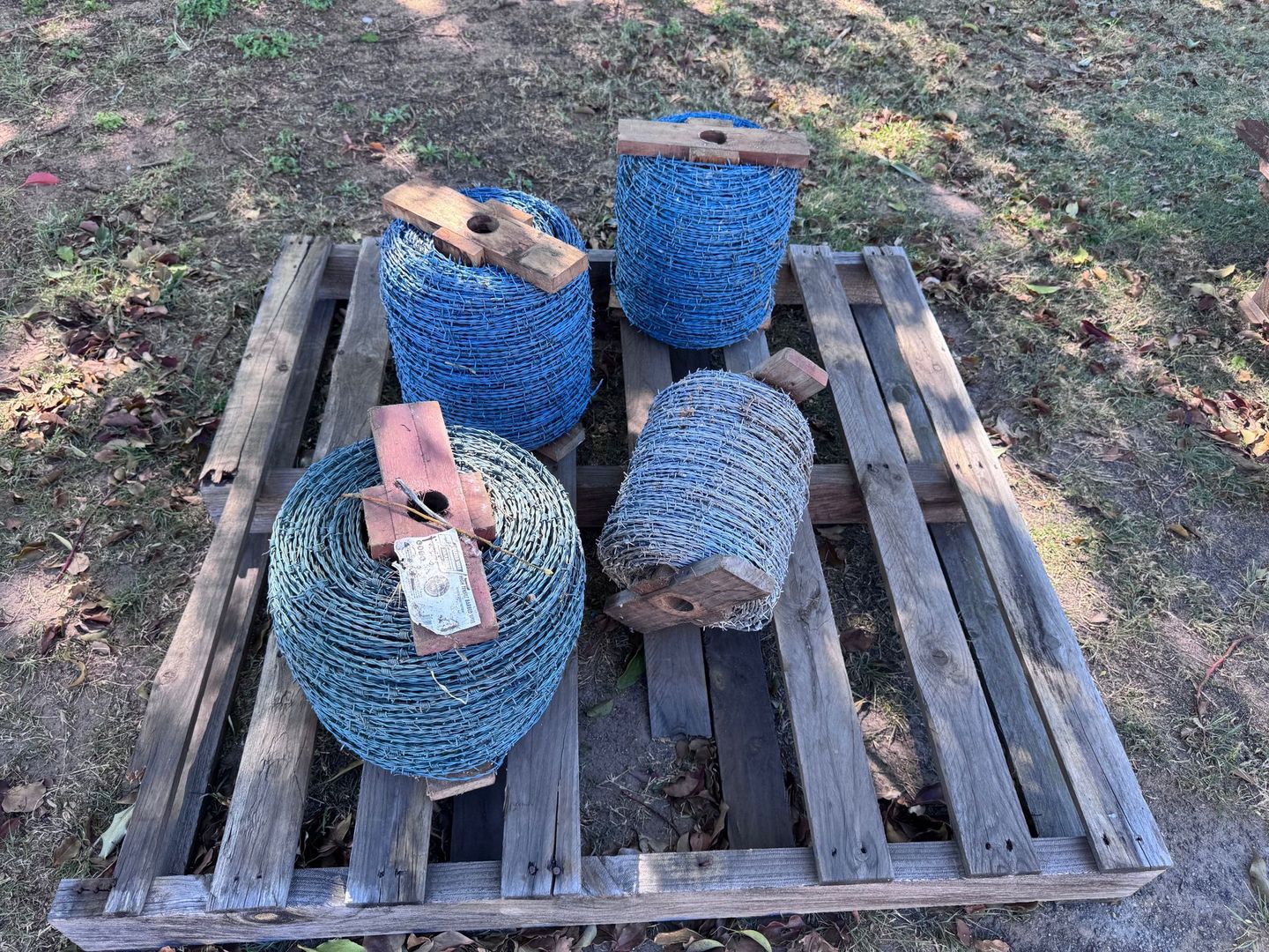 Four Spools of Barbed Wire, Blue and Green — Bundaberg Auction Centre in Gooburrum, QLD