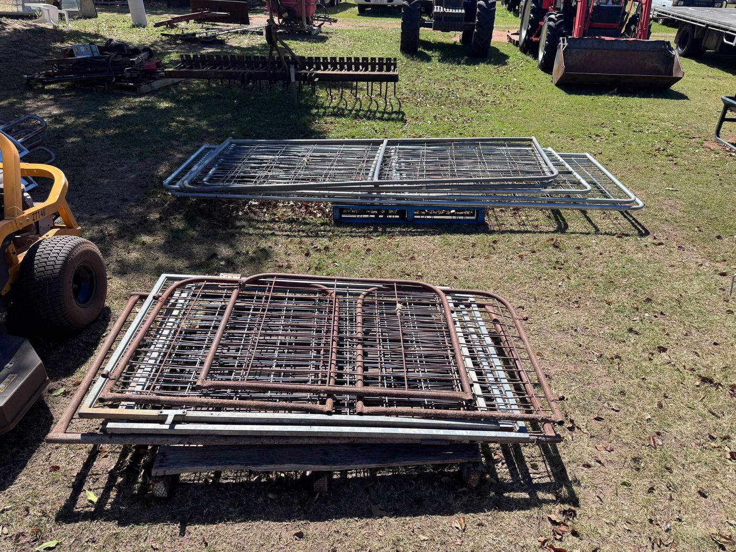 Several Metal Gates Stacked on Grass Outdoors — Bundaberg Auction Centre in Gooburrum, QLD
