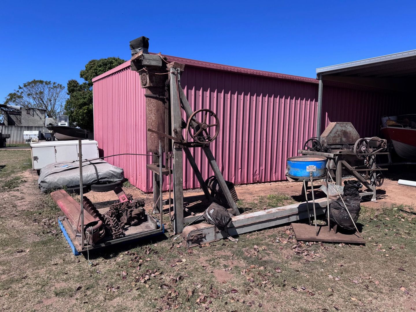 An Old Wooden and Metal Sawmill Sits Outside a Pink Corrugated — Bundaberg Auction Centre in Gooburrum, QLD