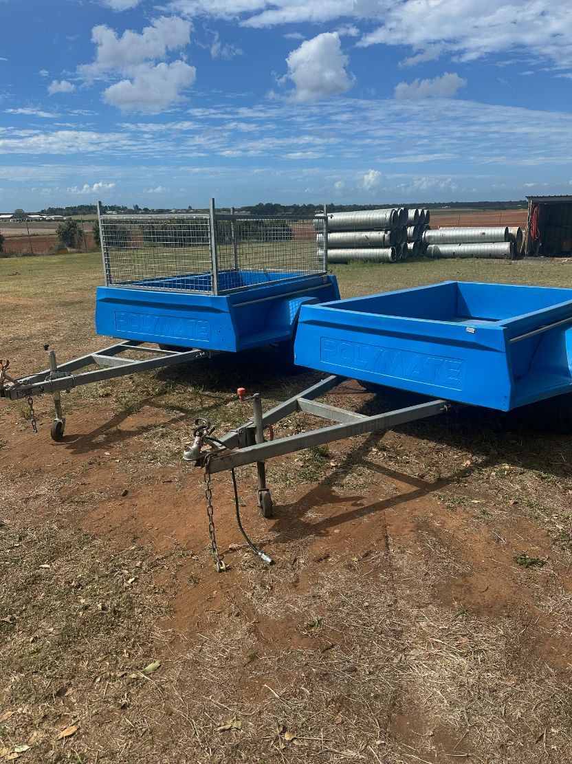 Two Blue Trailers on Brown Dirt, Under a Blue Sky — Bundaberg Auction Centre in Gooburrum, QLD