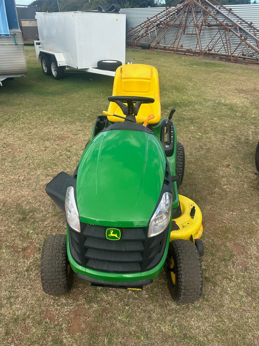 Green and Yellow John Deere Riding Lawn Mower on Grass — Bundaberg Auction Centre in Gooburrum, QLD
