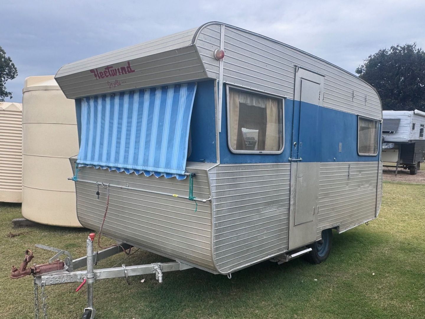 Vintage Blue and Silver Travel Trailer with Awning — Bundaberg Auction Centre in Gooburrum, QLD