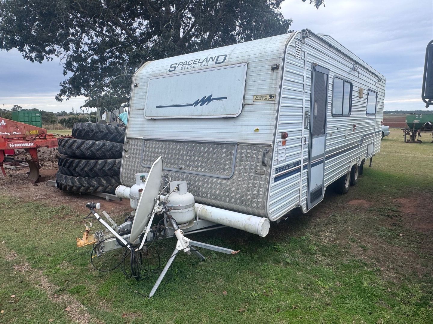 White Caravan with Satellite Dish, Parked on Grass — Bundaberg Auction Centre in Gooburrum, QLD
