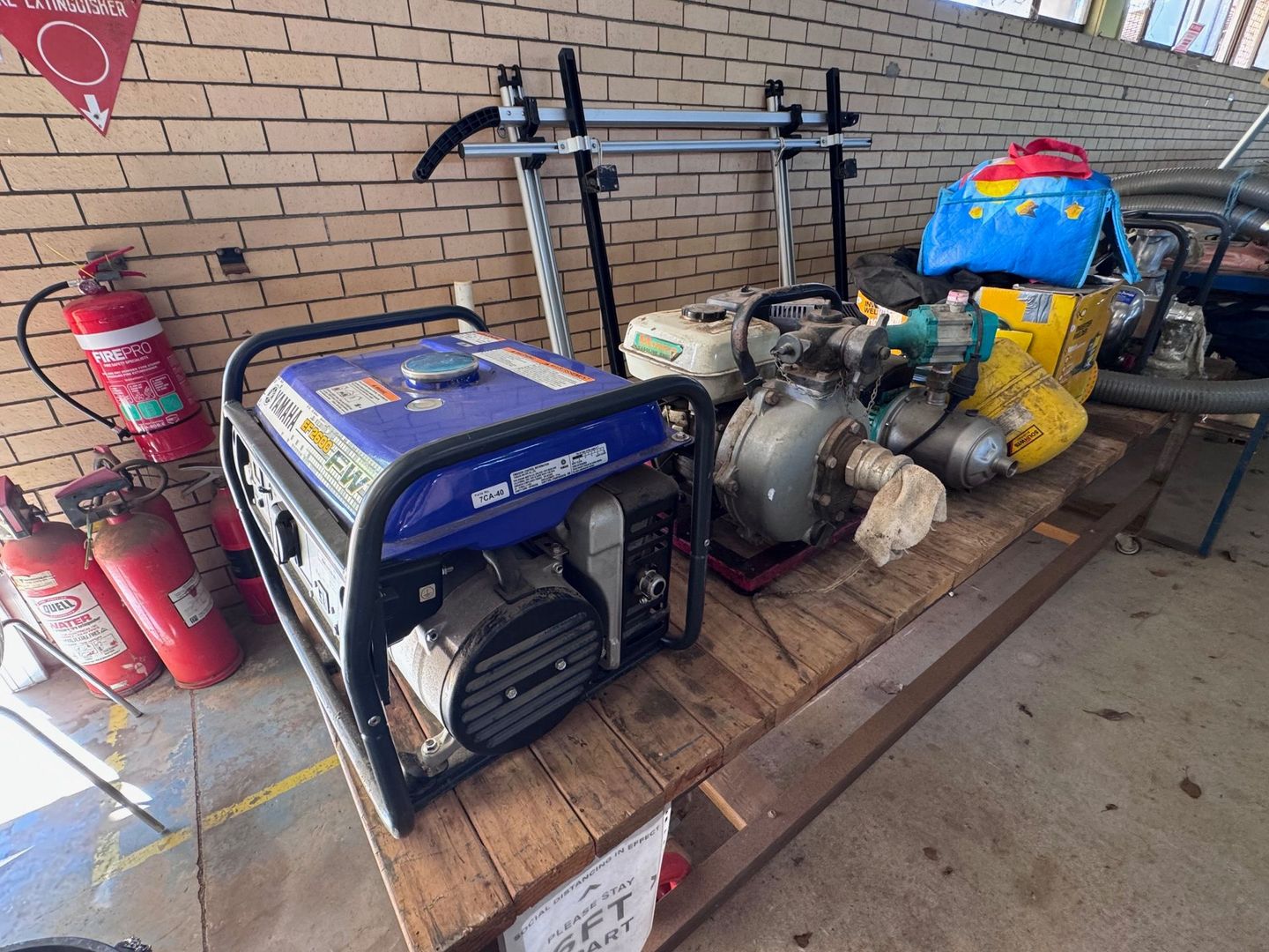 Various Tools on A Pallet Against a Brick Wall — Bundaberg Auction Centre in Gooburrum, QLD