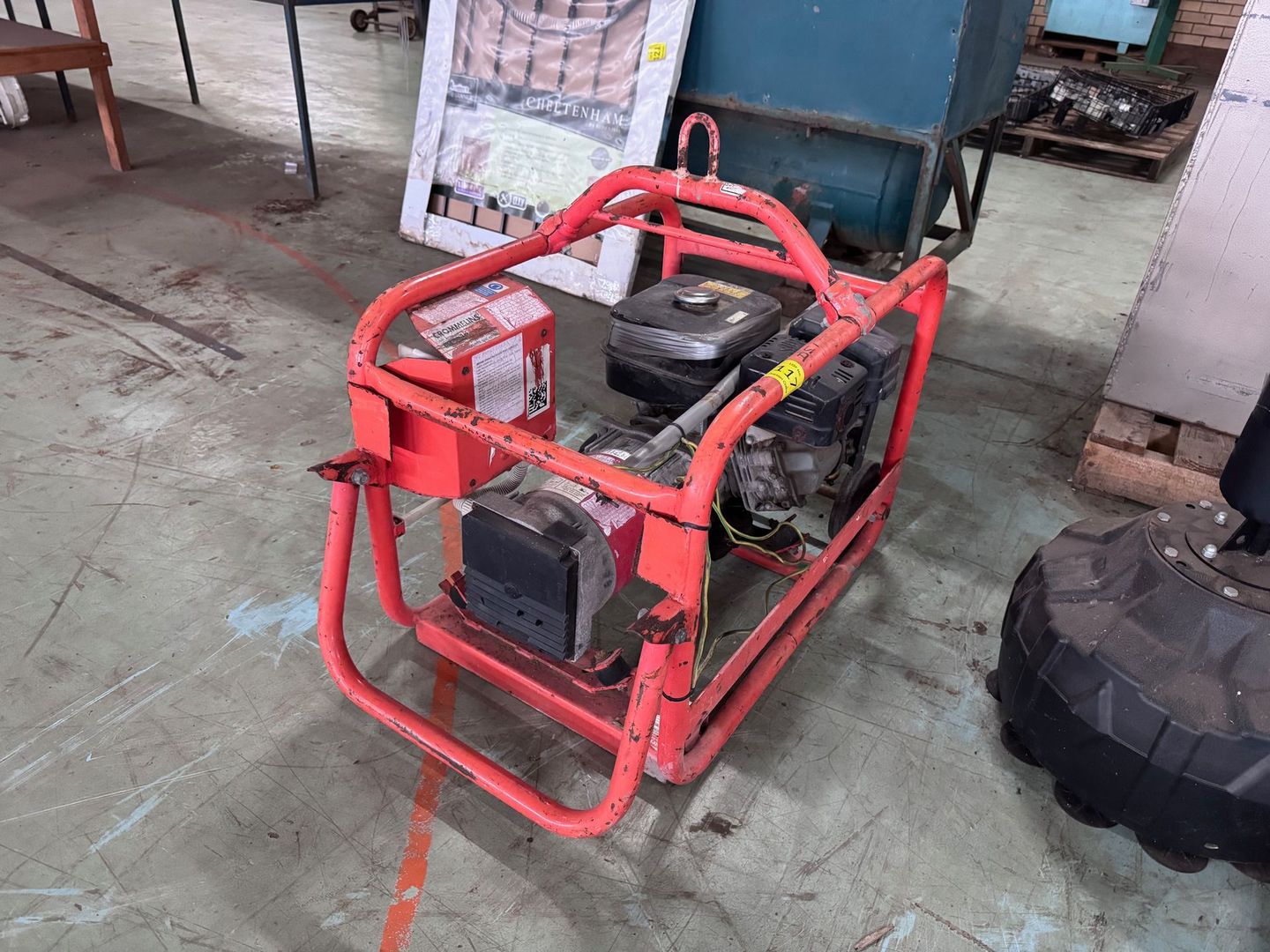 Red Portable Generator on A Concrete Floor — Bundaberg Auction Centre in Gooburrum, QLD
