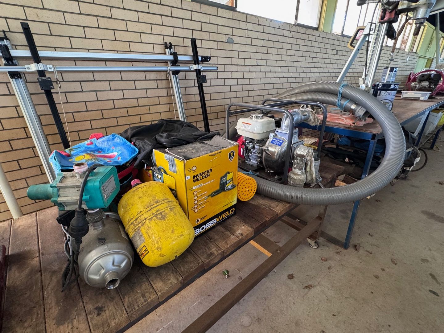 A Cluttered Workbench Holding Pumps — Bundaberg Auction Centre in Gooburrum, QLD