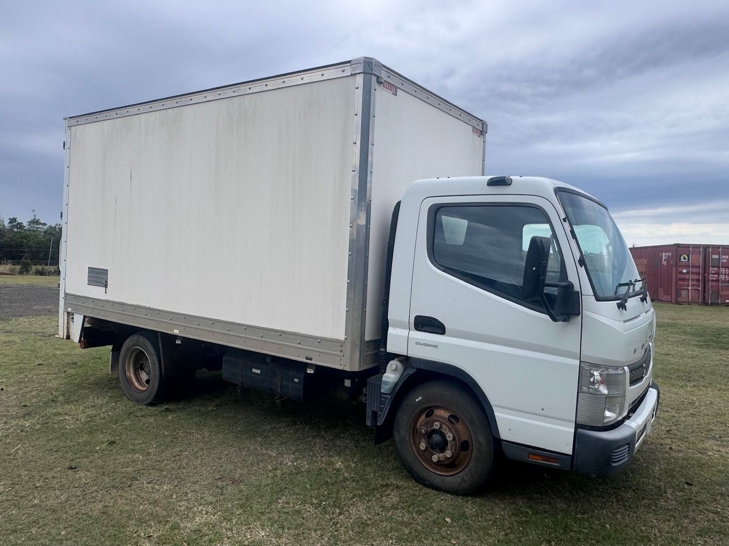 White Box Truck Parked on Grass, Overcast Day — Bundaberg Auction Centre in Gooburrum, QLD