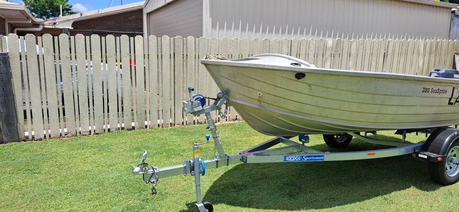 A Small Aluminum Boat on A Trailer, Parked on Grass — Bundaberg Auction Centre in Gooburrum, QLD