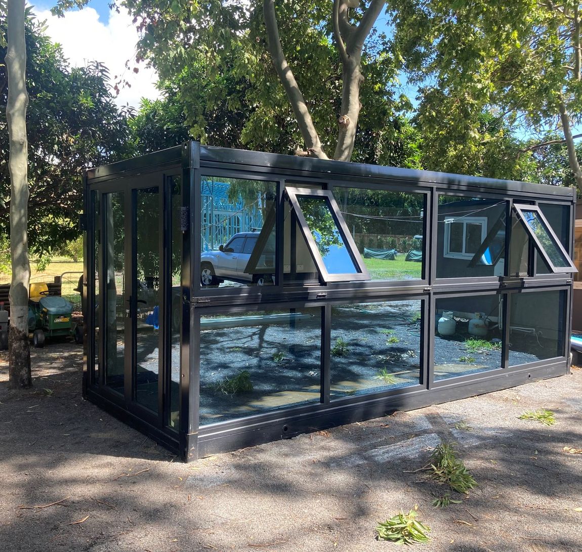 A building with a lot of windows and trees in the background