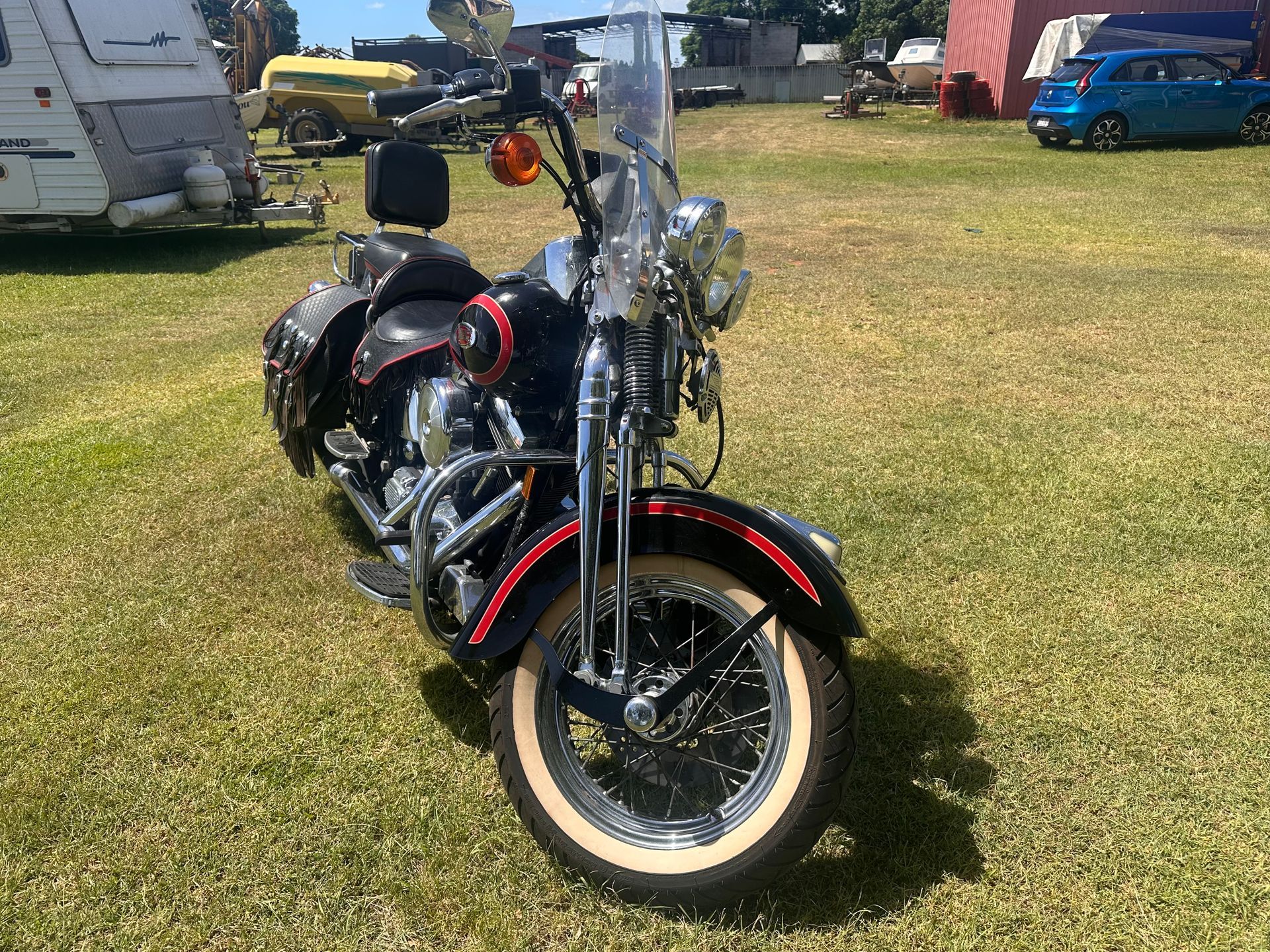 Black Harley-Davidson Motorcycle with White-Walled Tires Parked on Grass — Bundaberg Auction Centre in Gooburrum, QLD