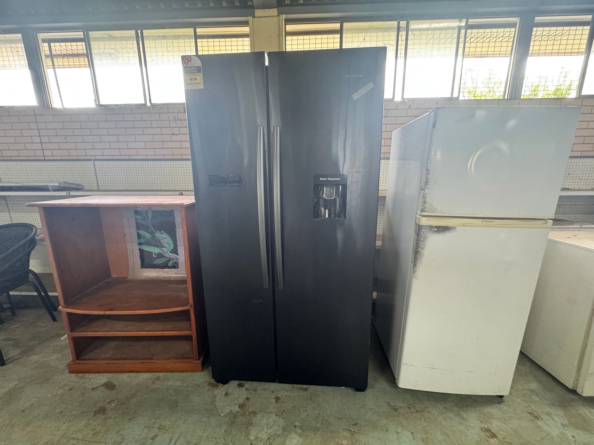 A Black Side-By-Side Refrigerator, a Wooden Cabinet — Bundaberg Auction Centre in Gooburrum, QLD