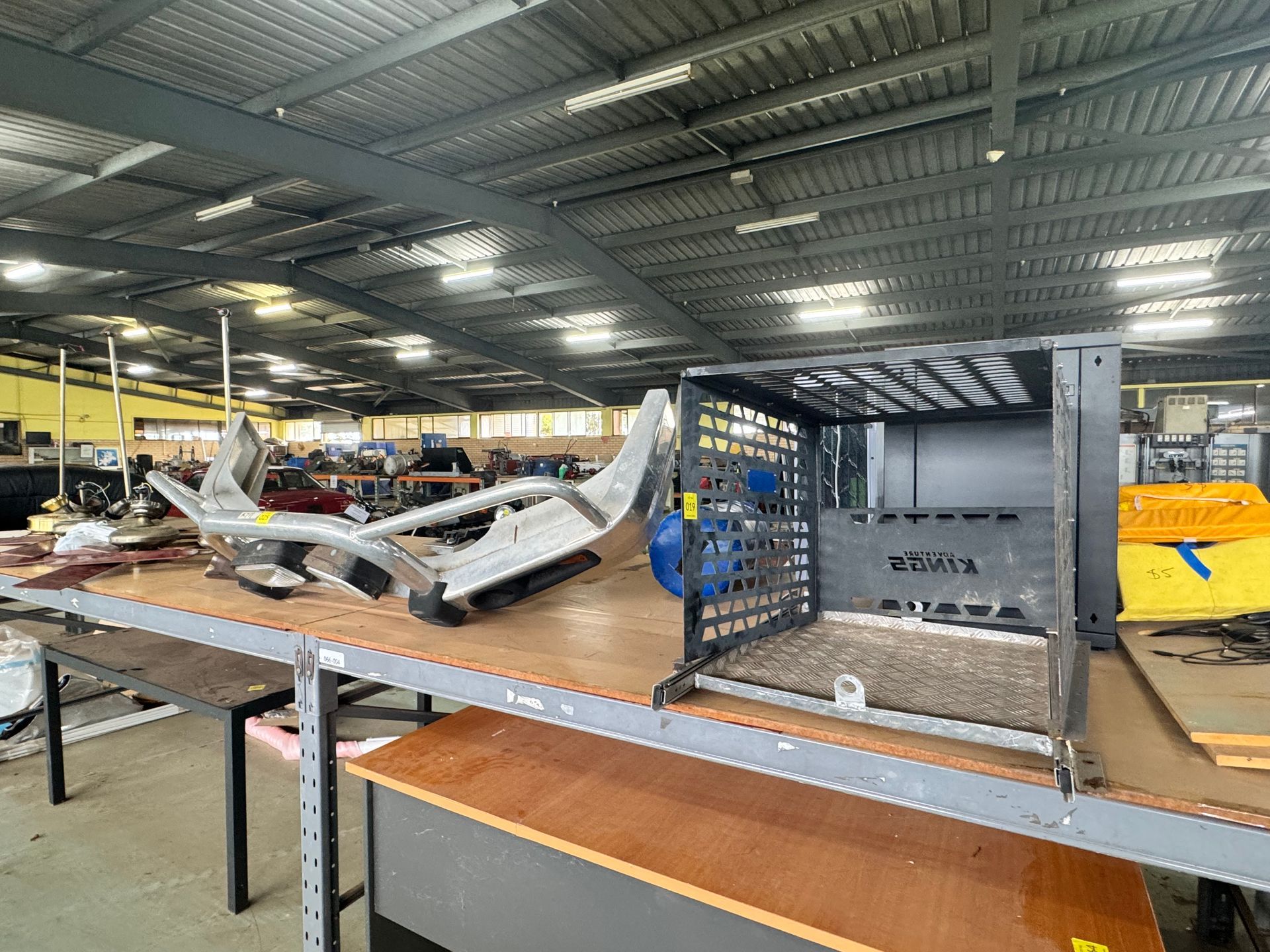 Inside a Cluttered Warehouse, a Metal Cage and Vehicle Parts — Bundaberg Auction Centre in Gooburrum, QLD