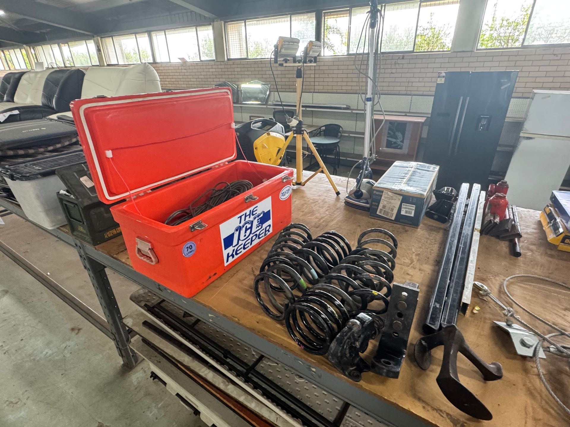 An Open Orange Cooler, Car Parts, and Equipment Are Arranged on A Wooden Table — Bundaberg Auction Centre in Gooburrum, QLD