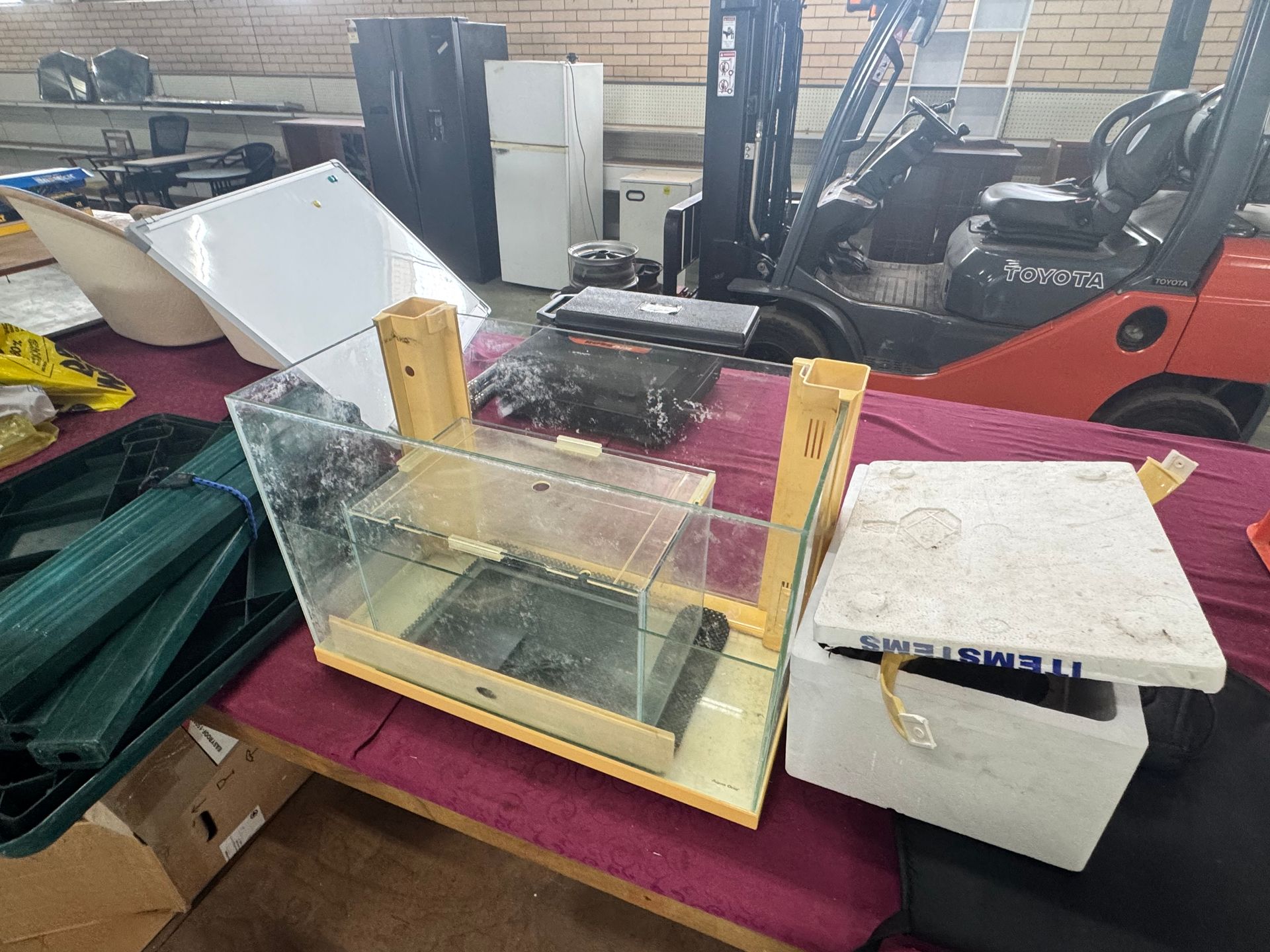 A Used Aquarium and White Styrofoam Container on A Red Table — Bundaberg Auction Centre in Gooburrum, QLD