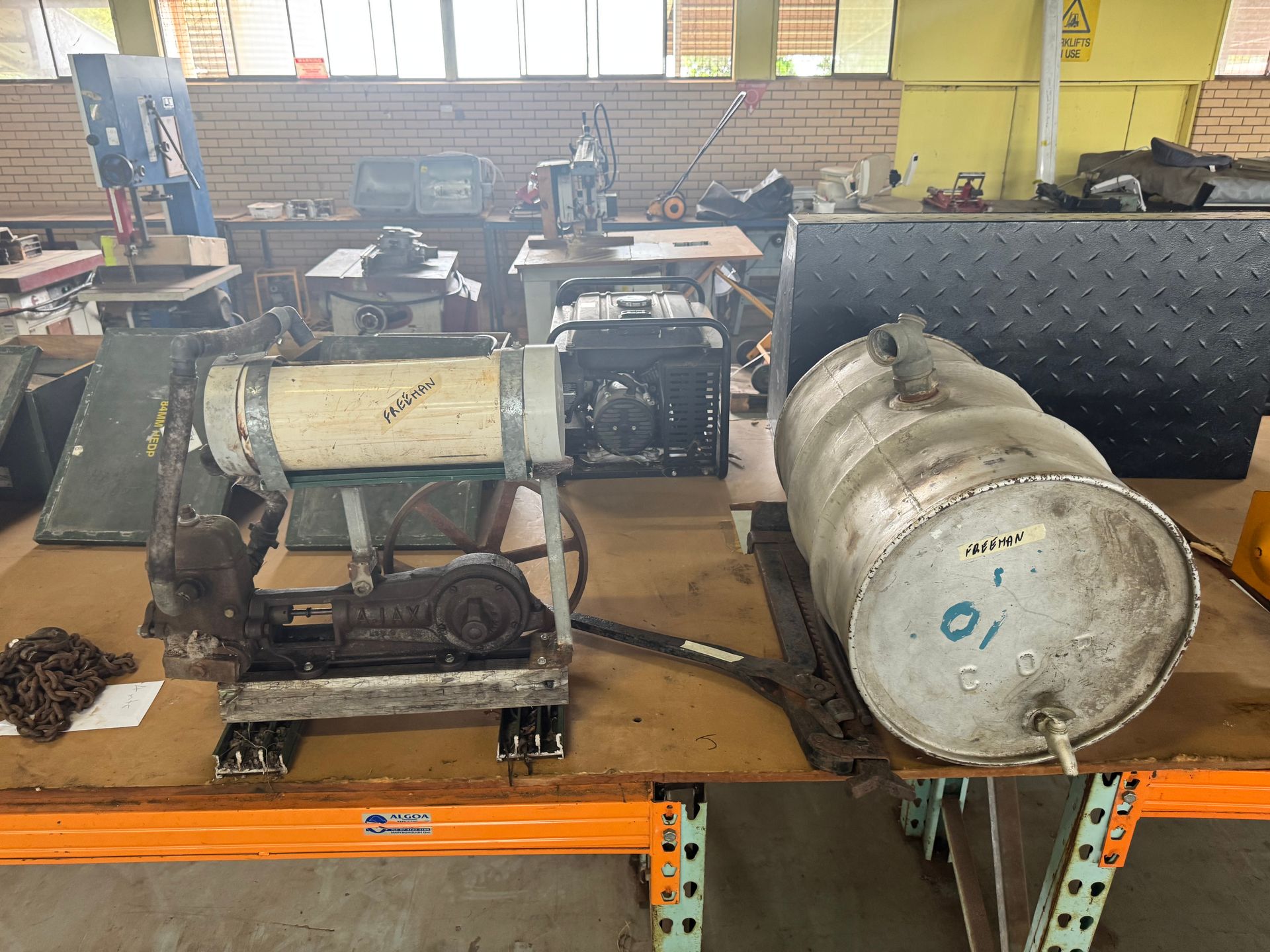Workshop Table with Metal Parts, a Generator, and A Cylindrical Tank — Bundaberg Auction Centre in Gooburrum, QLD