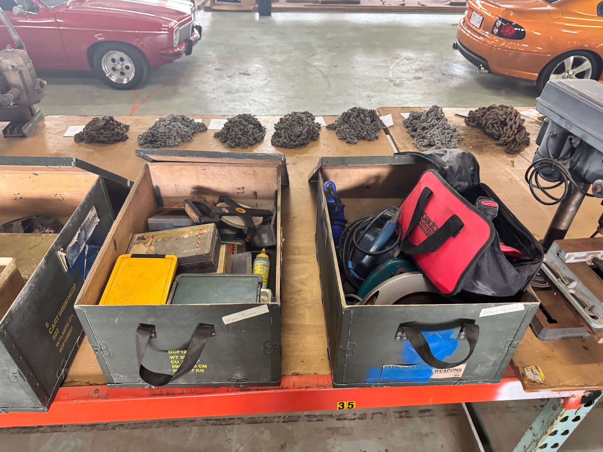 Two Boxes of Tools and Metal Debris on A Table with Classic Cars in The Background  — Bundaberg Auction Centre in Gooburrum, QLD