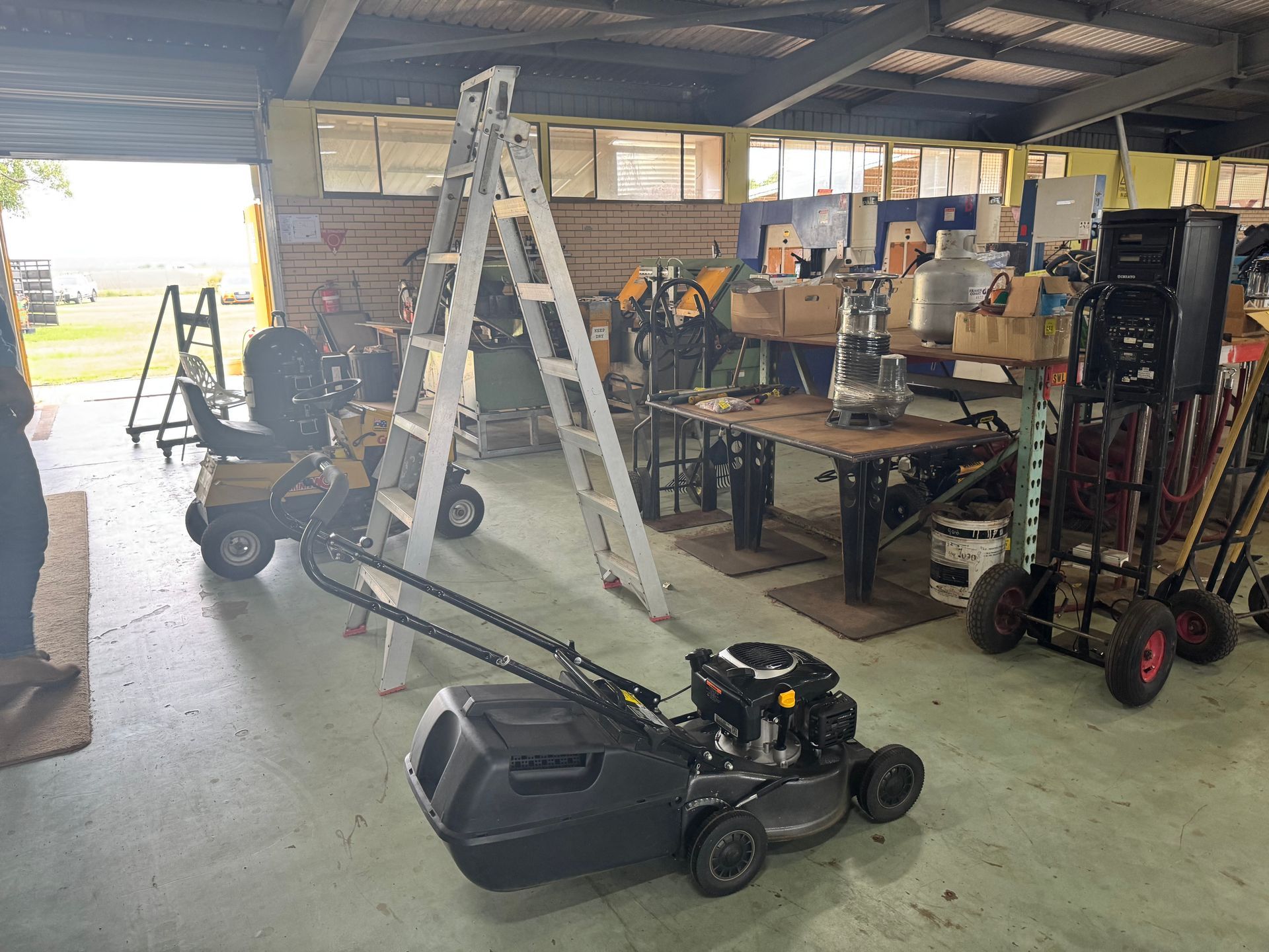 A Garage with A Lawnmower, Ladder, and Other Tools, Including a Motorized Wheelchair — Bundaberg Auction Centre in Gooburrum, QLD