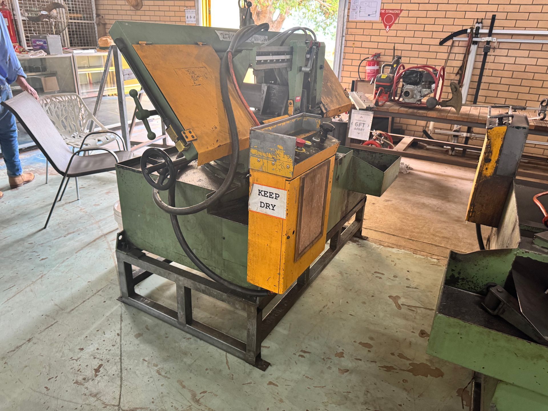 Metalworking Bandsaw in A Workshop, Yellow and Green, on A Metal Frame — Bundaberg Auction Centre in Gooburrum, QLD