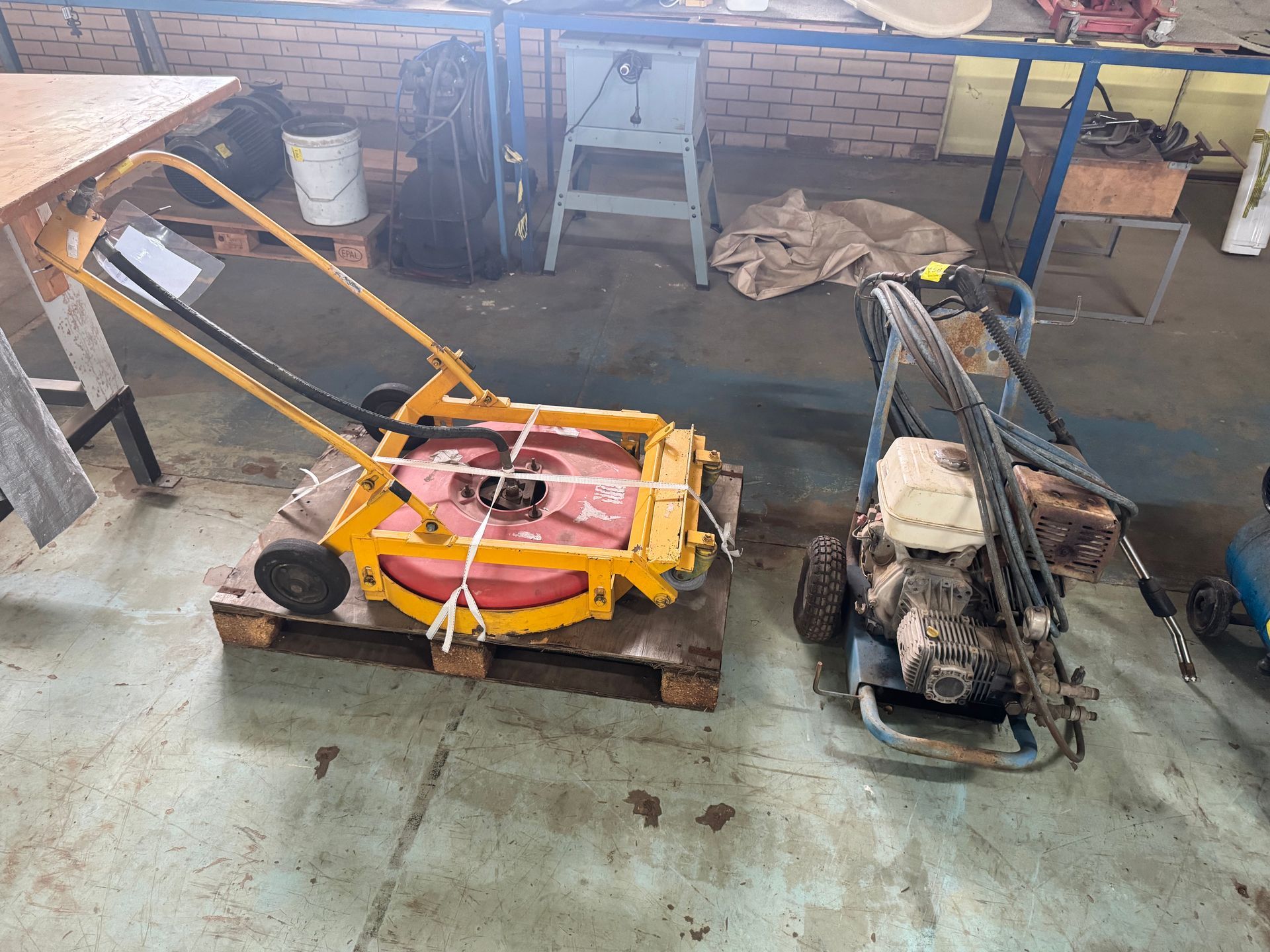 Yellow Lawnmower and Pressure Washer on A Pallet in A Workshop — Bundaberg Auction Centre in Gooburrum, QLD
