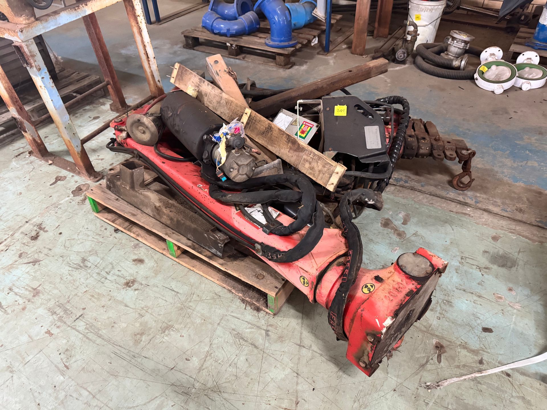 Red Industrial Machinery Parts on A Wooden Pallet — Bundaberg Auction Centre in Gooburrum, QLD