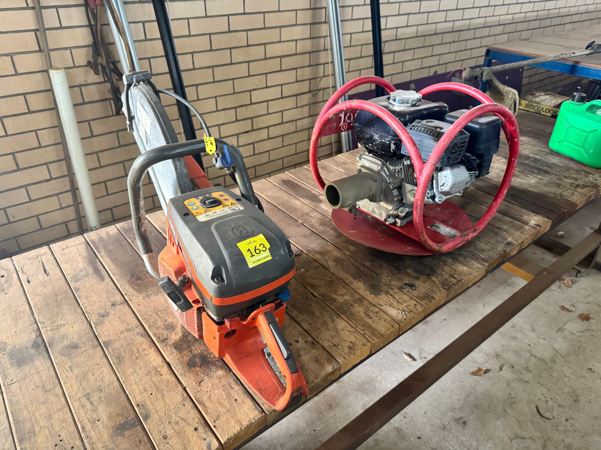 Chainsaw and Vibratory Plate Compactor on A Wooden Surface, Set Outdoors — Bundaberg Auction Centre in Gooburrum, QLD
