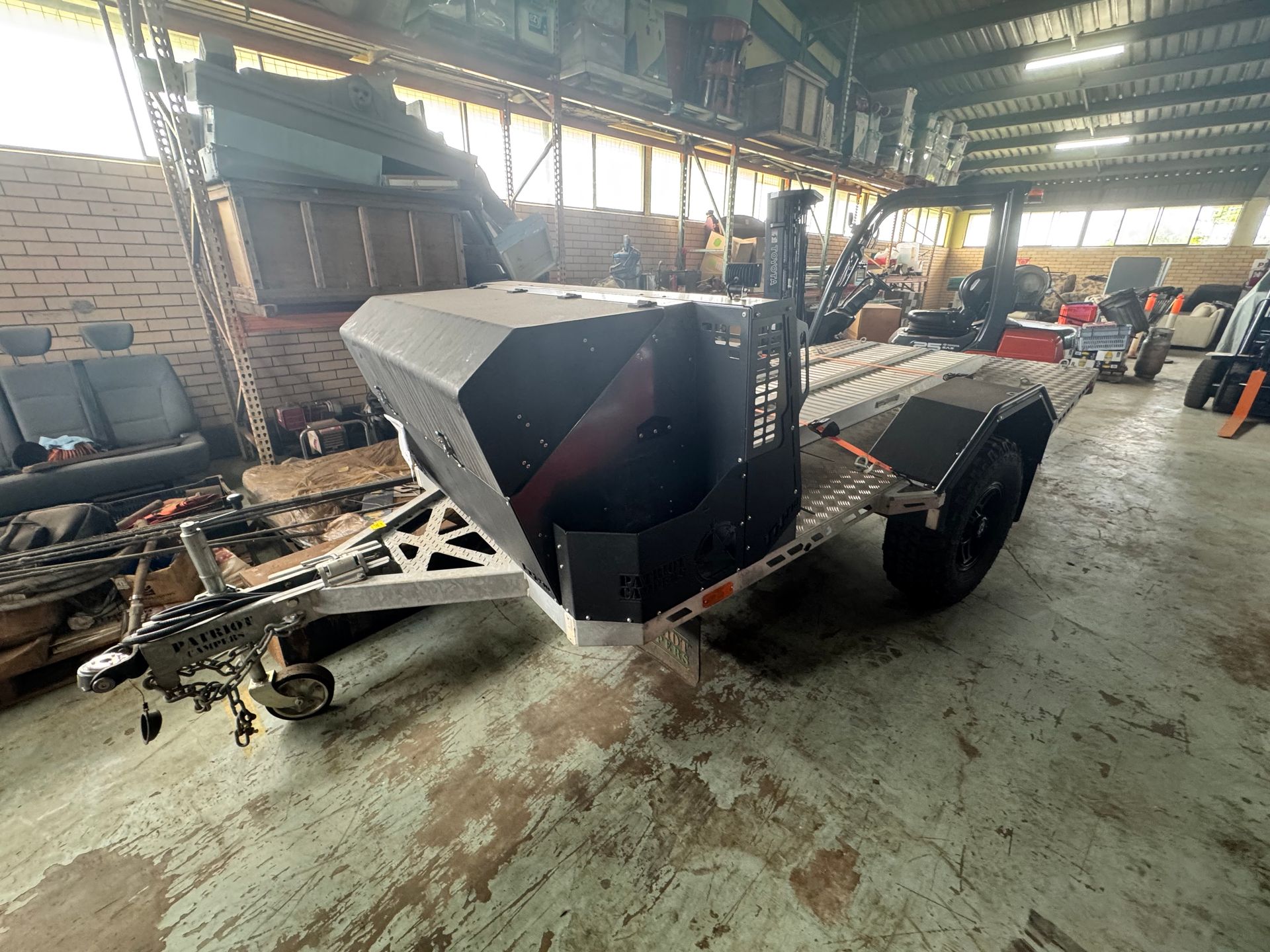 Black Armored Robot in A Workshop, Mounted on A Wheeled Platform — Bundaberg Auction Centre in Gooburrum, QLD