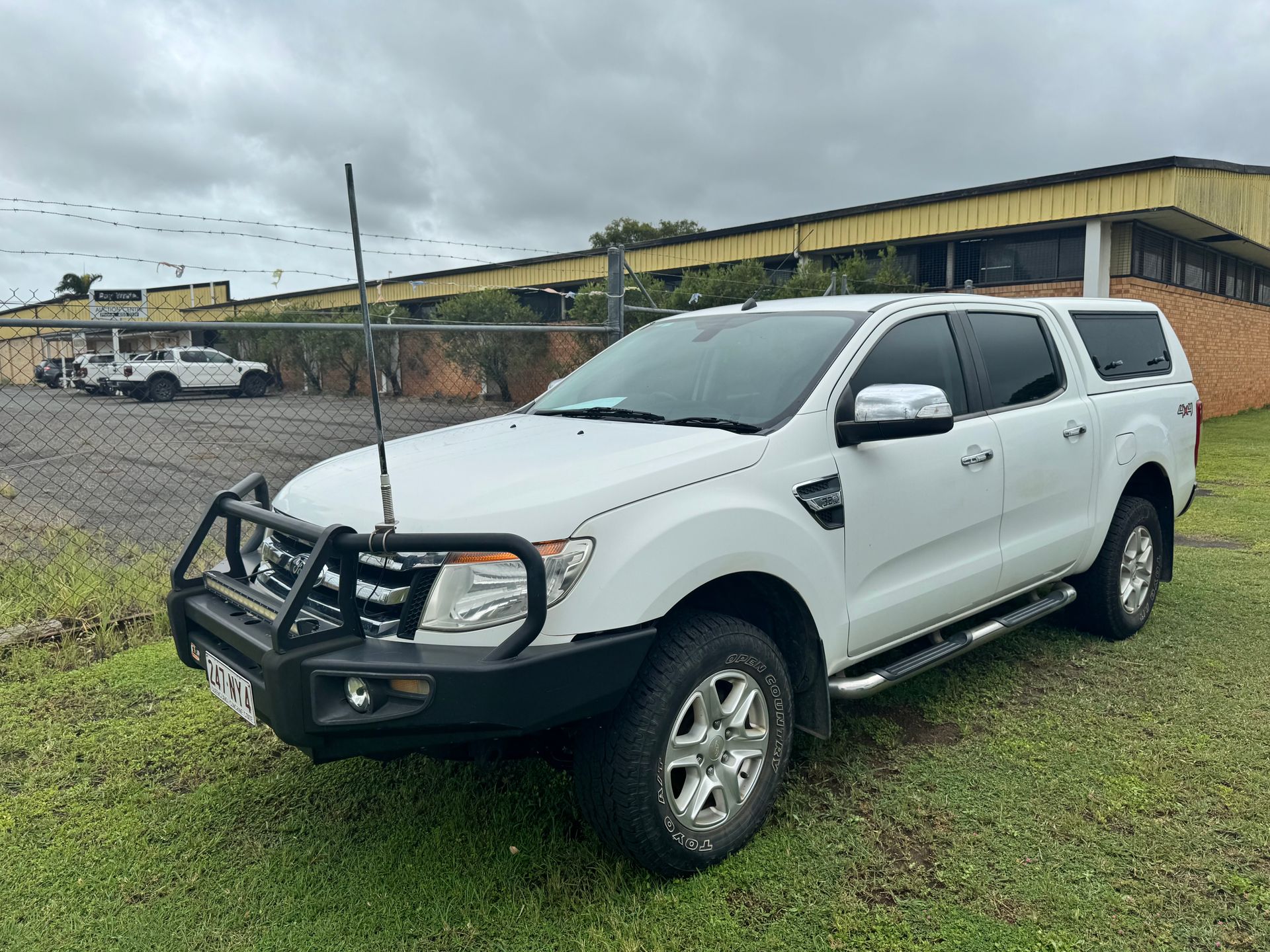 White Ford Ranger Pickup Truck with A Bull Bar, Parked on Grass — Bundaberg Auction Centre in Gooburrum, QLD