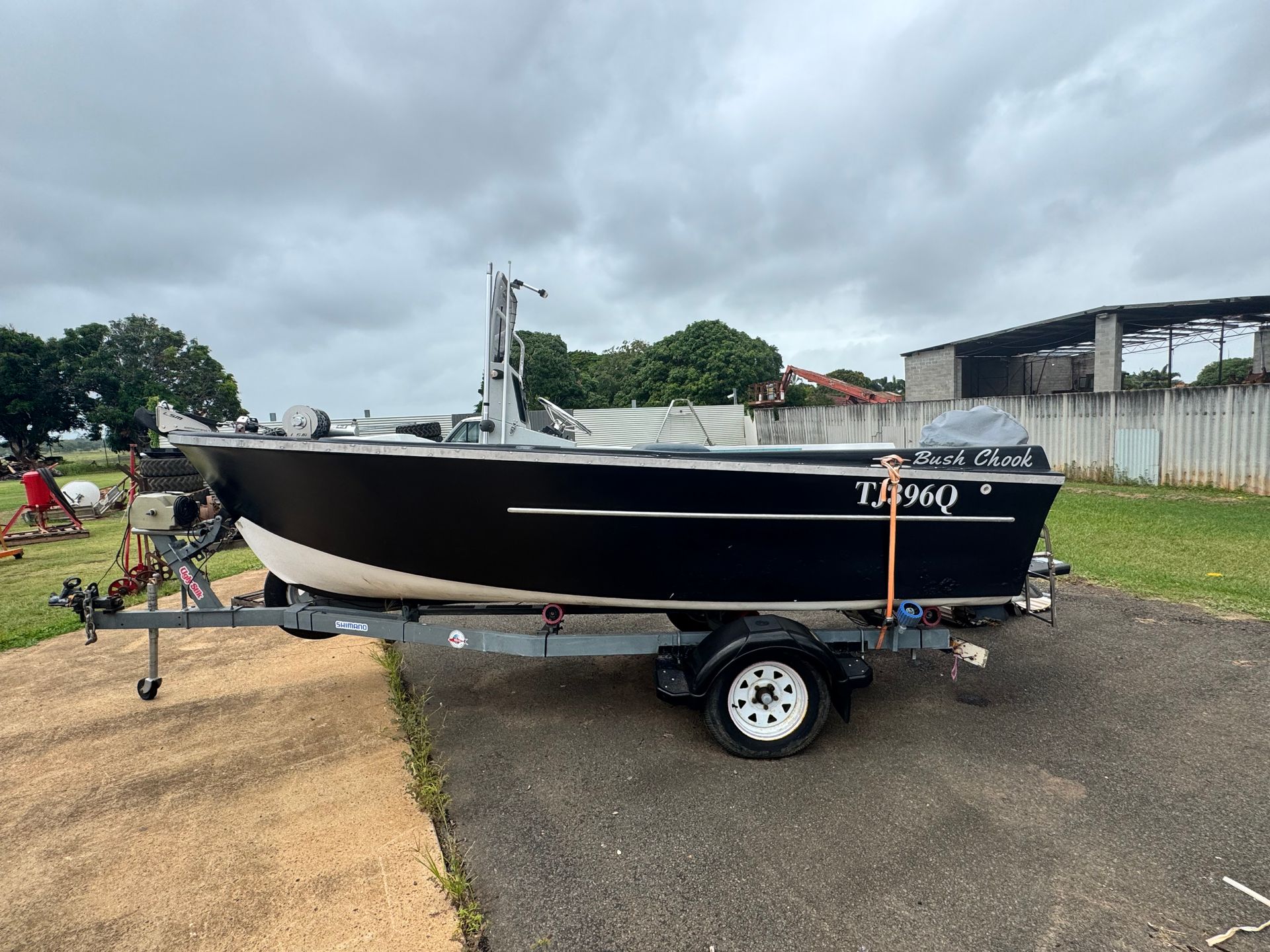 Black and White Boat on A Trailer, with A Cloudy Sky Backdrop — Bundaberg Auction Centre in Gooburrum, QLD