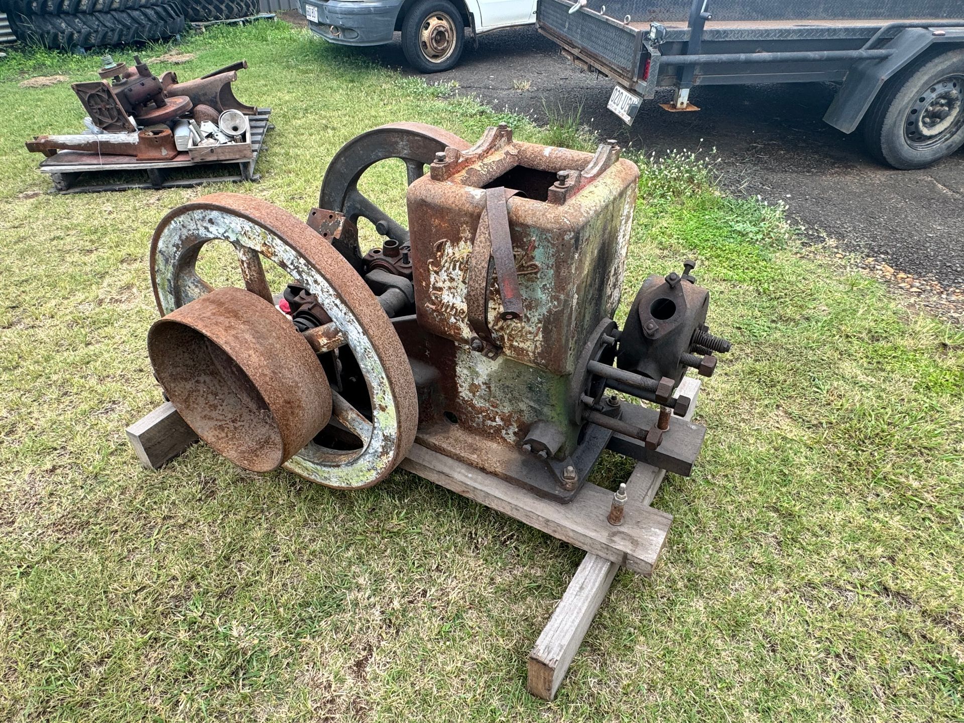 Rusty Vintage Engine on Wooden Base Outdoors — Bundaberg Auction Centre in Gooburrum, QLD