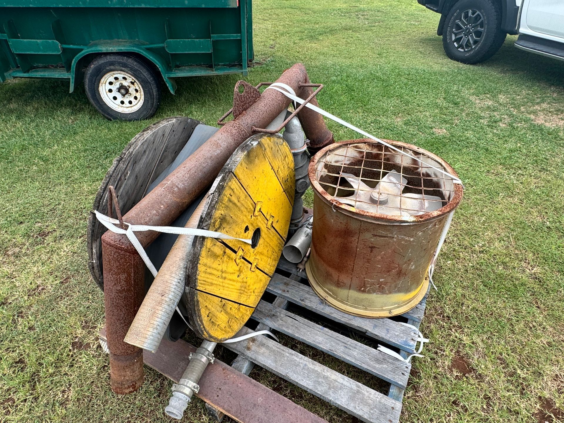 Pile of Metal Scrap Tied Together on A Wooden Pallet, with A Trailer and Truck Tire in The Background — Bundaberg Auction Centre in Gooburrum, QLD