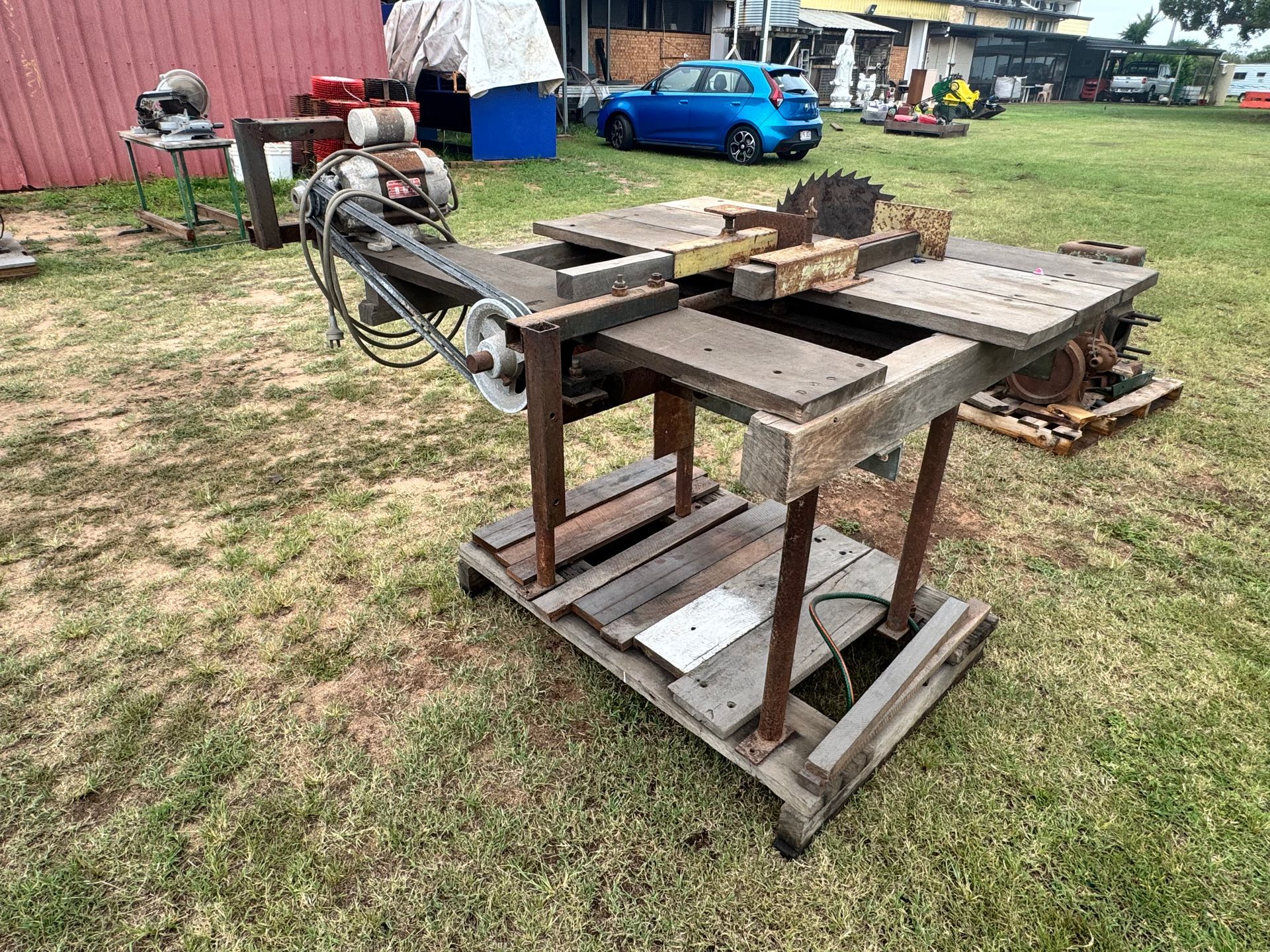 Homemade Table Saw on Wooden Base, in A Grassy Outdoor Setting — Bundaberg Auction Centre in Gooburrum, QLD